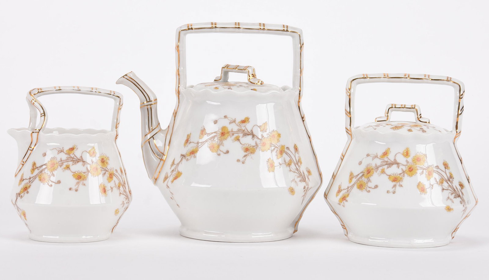 Three piece T&V Limoges tea set: Three piece T&V Limoges tea set; 8" 8" Teapot, creamer and sugar - white with daisy decor and gold stencil highlights; Hopper Collection, Kansas