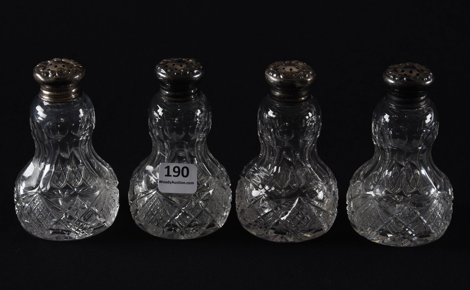 (4) Salt/pepper shakers, American brilliant cut glass: (4) Salt/pepper shakers, American brilliant cut glass; 4" All same shape and pattern, gourd shape with crosscut diamond, star and fan motif, sterling lids, one has base chip, all have pattern roughnes