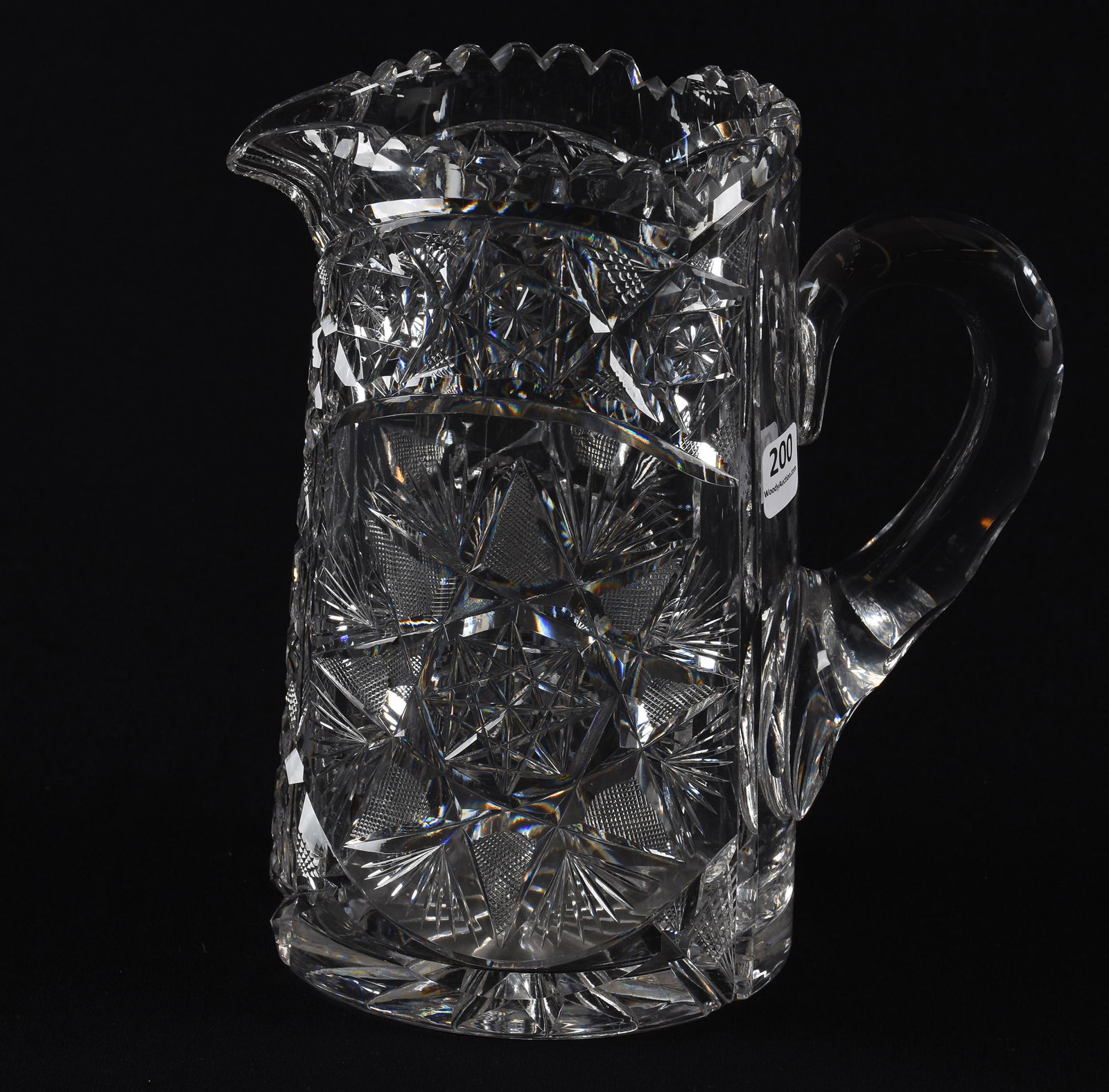 Water pitcher, American brilliant cut glass: Water pitcher, American brilliant cut glass; 8" Flashed hobstar with hobstar chain motif, double notched handle, ray cut base, some base roughness; Hopper Collection, Kansas