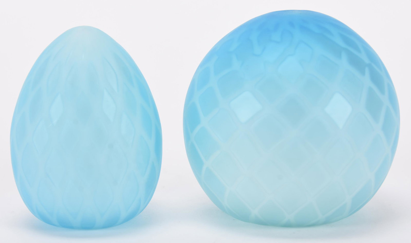 (2) Contemporary art glass paperweights: (2) contemporary art glass paperweights; 3.5" Blue satin diamond quilted; (1) egg-shaped; (1) ball-shaped; Hopper Collection, Kansas