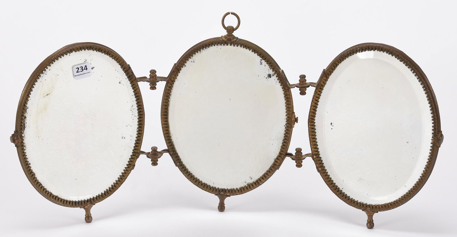 Triptych three section beveled vanity mirror: Triptych three section beveled vanity mirror; 9" x 20.5" Black leather backing, brass hinged frame; Hopper Collection, Kansas