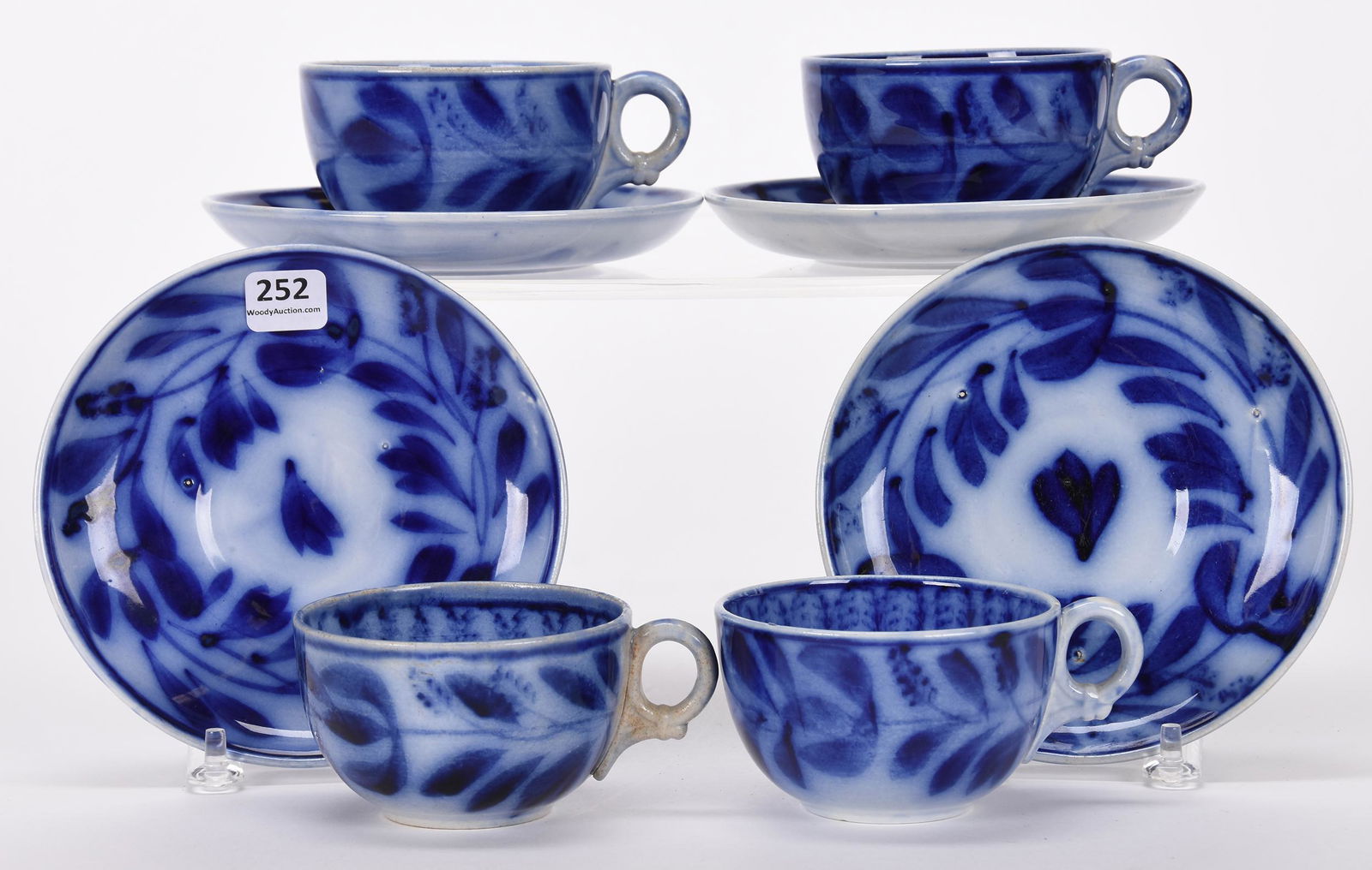 (4) Flow blue coffee cups and saucers: (4) Flow blue coffee cups and saucers; Spinach pattern, one handle discolored ; Hopper Collection, Kansas