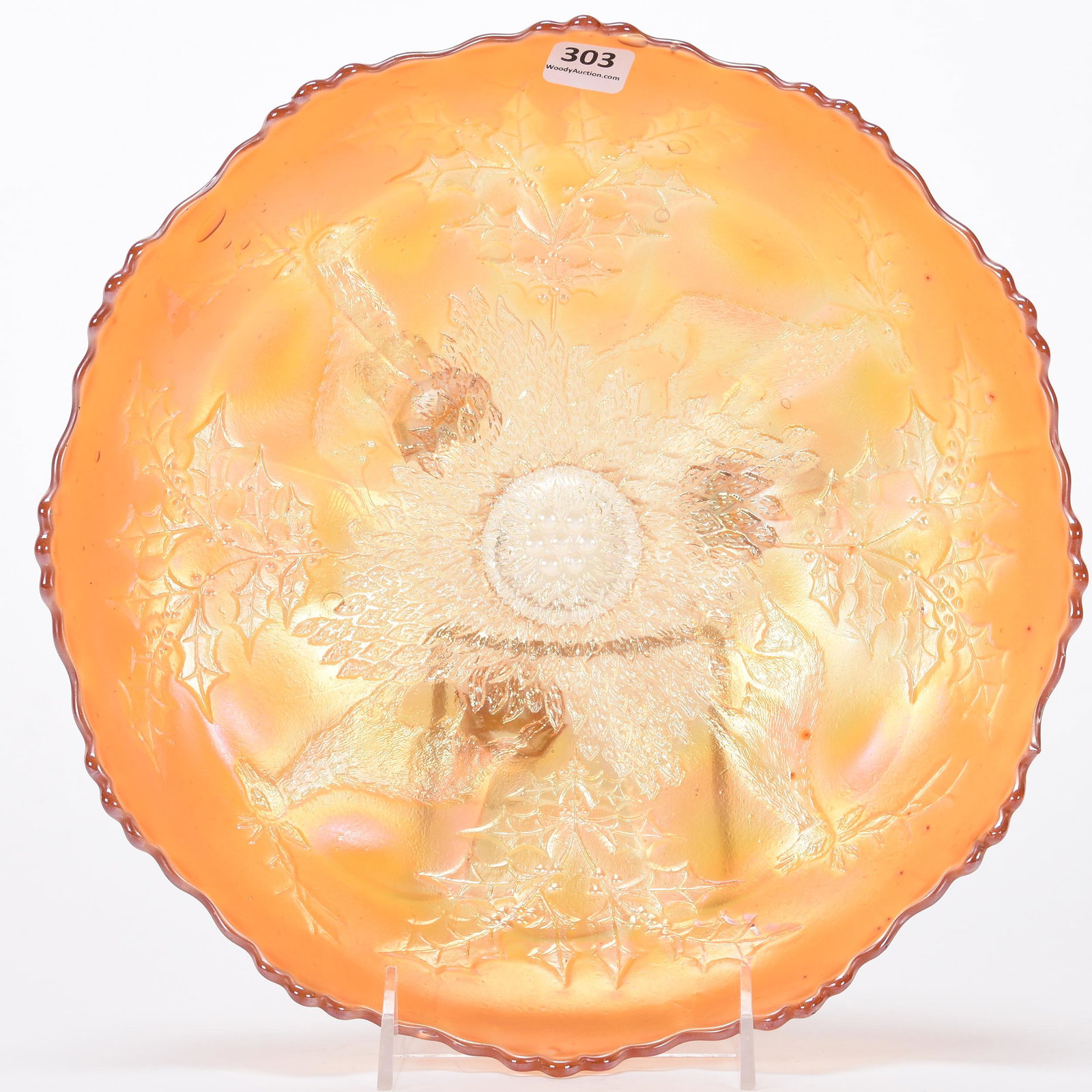 Carnival Glass bowl: Carnival Glass bowl; 10.75'; Stag & Holly by Fenton, three footed, marigold, ice cream shape; Hopper Collection, Kansas