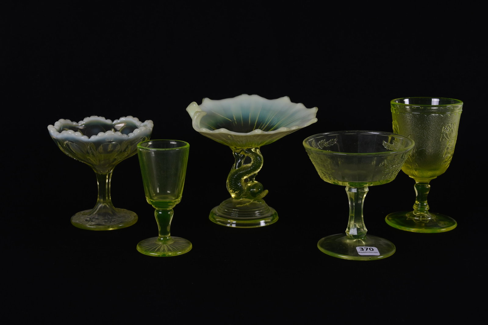 (5) Vaseline & opalescent items: (5) Vaseline & opalescent items; (1) 5.75" goblet, rose decor; (1) 5.5" opalescent dolphin compote; (1) 4.75" opalescent jelly compote, Iris pattern; (1) 4.5" jelly compote with floral design; (1) 4.5
