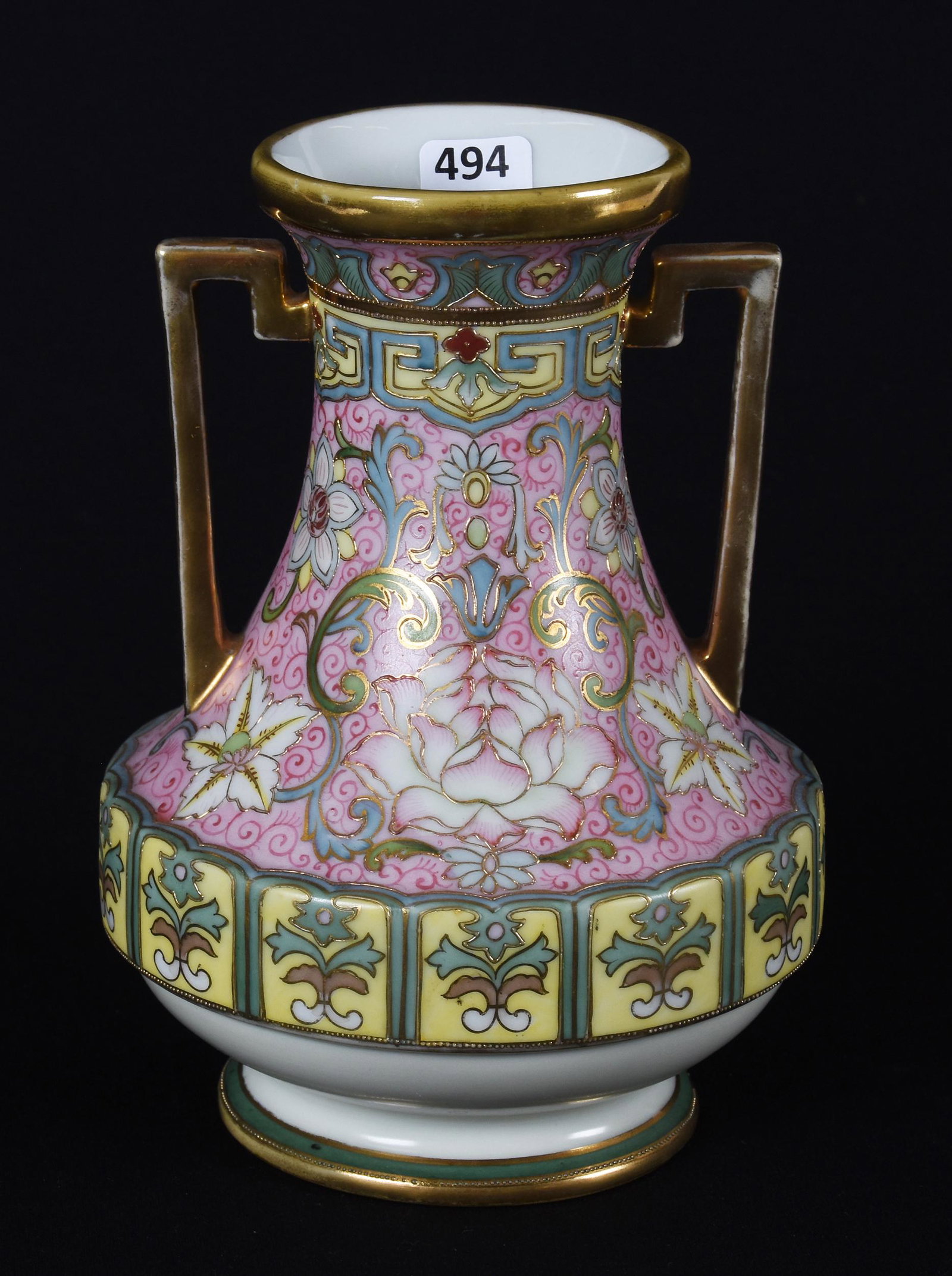 Vase marked Nippon (green wreath): Vase marked Nippon (green wreath); 8" ; Two-handled, pink and yellow tones with elaborate design and gold trim highlights; Callahan Collection, Oklahoma