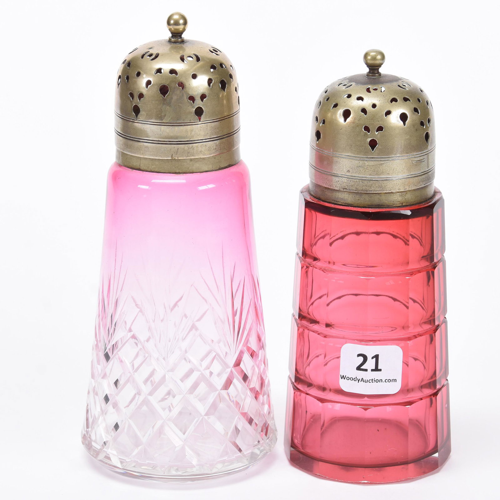 (2) Art Glass Sugar Shakers: (2) Art Glass Sugar Shakers; 6.25" 5.75" (1) 5.75" Cranberry with Cube Design, (1) 6.25" Rubina Diamond Fan Motif, Both Have Silverplate Tops; Balliet Collection, Mississippi