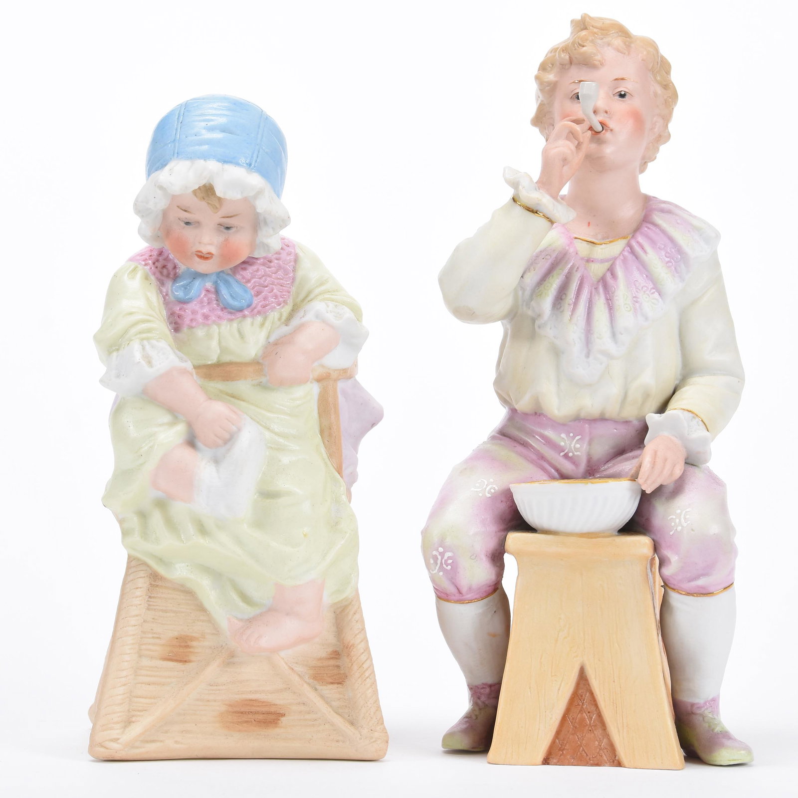 (2) Heubach Bisque Figurines, Marked: (2) Heubach Bisque Figurines, Marked; (1) 9" Boy Seated on Stool & Blowing Bubbles, (1) 7.75" Child in Highchair Pulling Off Socks; Balliet Collection, Mississippi
