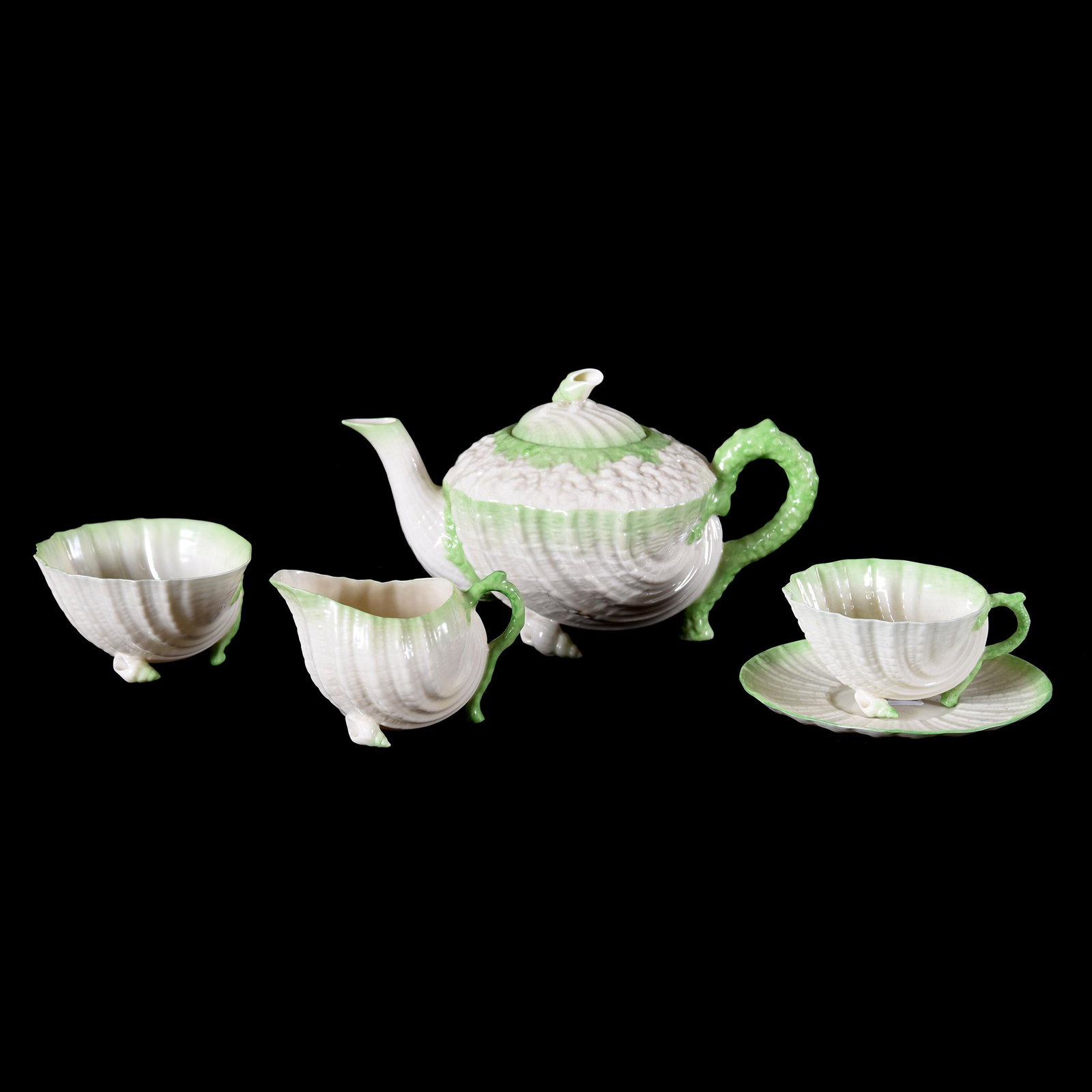 (4) Pc. Tea Set, Irish Belleek Black Mark, Neptune: (4) Pc. Tea Set, Irish Belleek Black Mark, Neptune, (1) 5" x 8.5" Teapot, (1) Creamer, (1) Sugar, (1) Cup & Saucer, Green Highlights, from the estate of Ronald W. Prielipp PHD, Salina, KS. Ron was a p