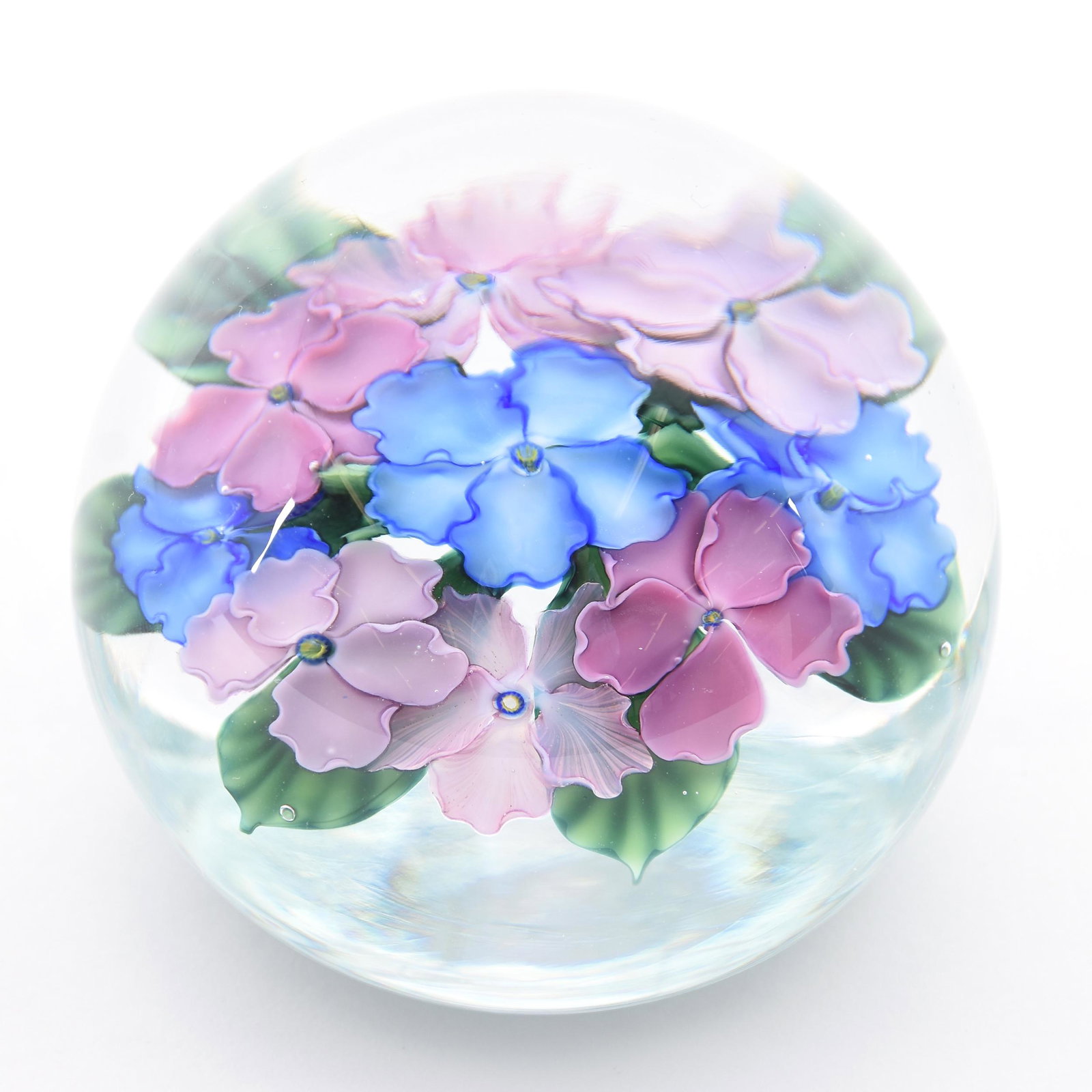 Paperweight Signed Lundberg Studios Dated 1987: Paperweight Signed Lundberg Studios Dated 1987, 3" Diameter, Clear with Pink and Blue Pansy Field Decor, Artist Signed Daniel Salazar, from the estate of Ronald W. Prielipp PHD, Salina, KS. Ron was a 