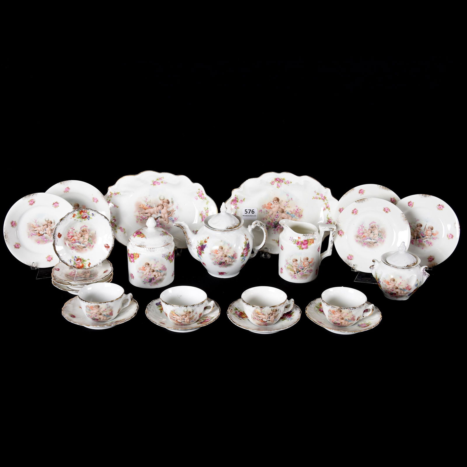 (19) Piece Child's Tea Set, Prov Saxe: (19) Piece Child's Tea Set, Prov Saxe, White with Colorful Floral and Cherub Scenic Decor, (1) 4.25" x 5.5" Tea Pot, Creamer & Two Styles of Covered Sugar Bowls, (2) 7" Trays, (5) 4" Plates, (4) 3" Pl