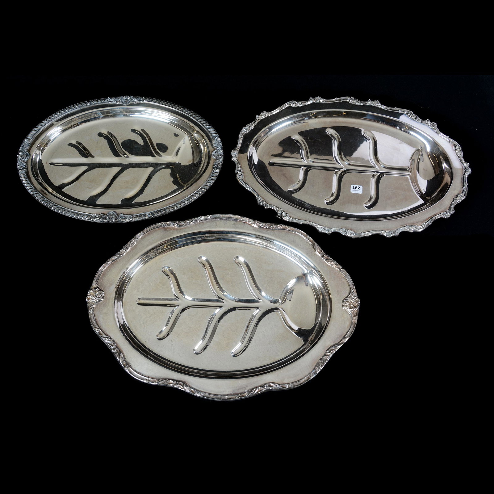 (3) Silverplate Turkey Platters: (3) Silverplate Turkey Platters, (1) 18" X 12.75", English Hallmarks, (1) 18" X 12.5", American Rose Pattern by Wilcox, International Silver, (1) 15.75" X 11.5", Bristol Silverplate #23, Private Colle