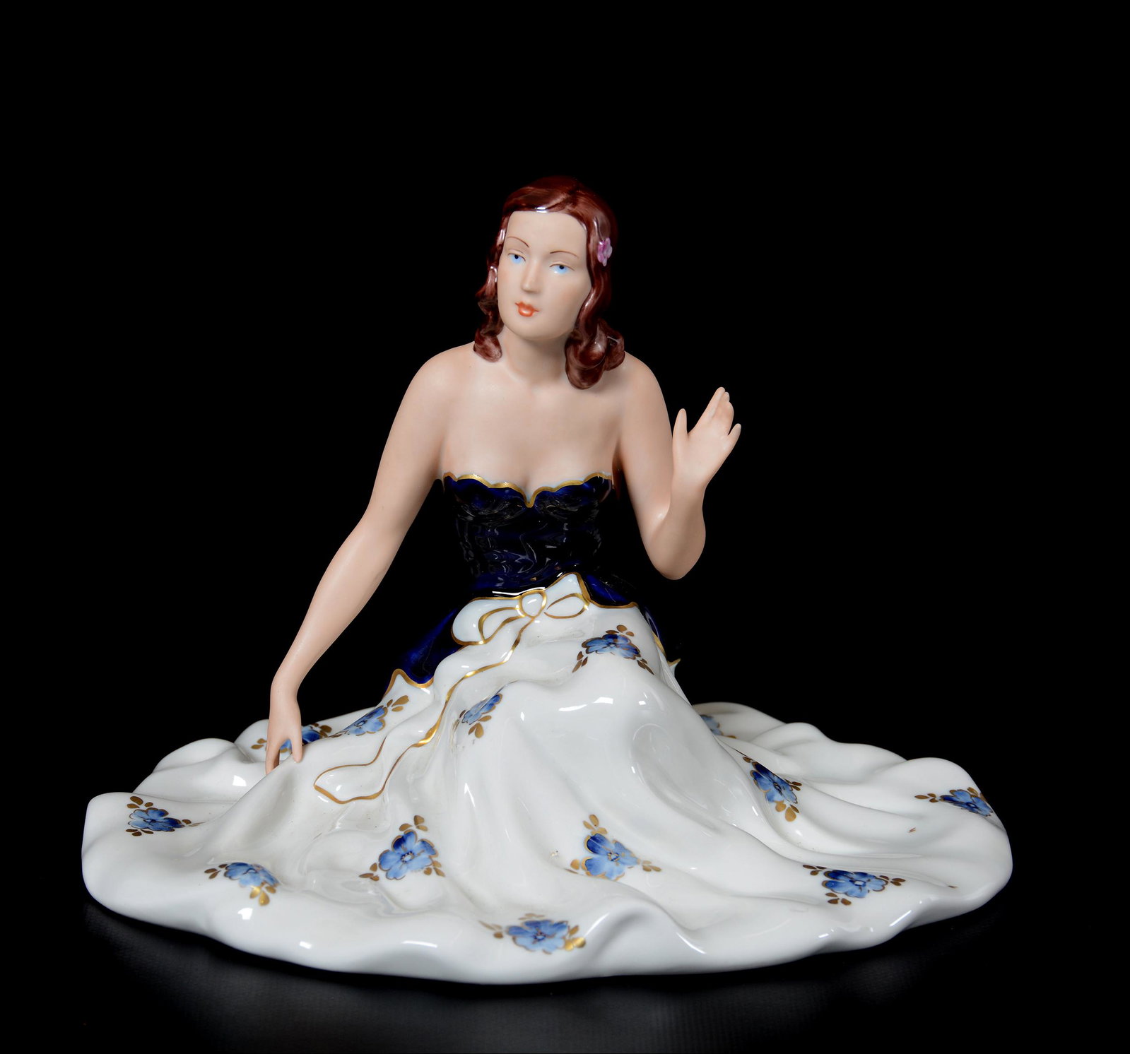 Royal Dux Figurine: Royal Dux Figurine, 7" X 9.75", Woman in Elaborate Dress, Cobalt Blue Bodice with White Skirt; the Collection of Mrs. R. and the Late Dr. S. Alexander.