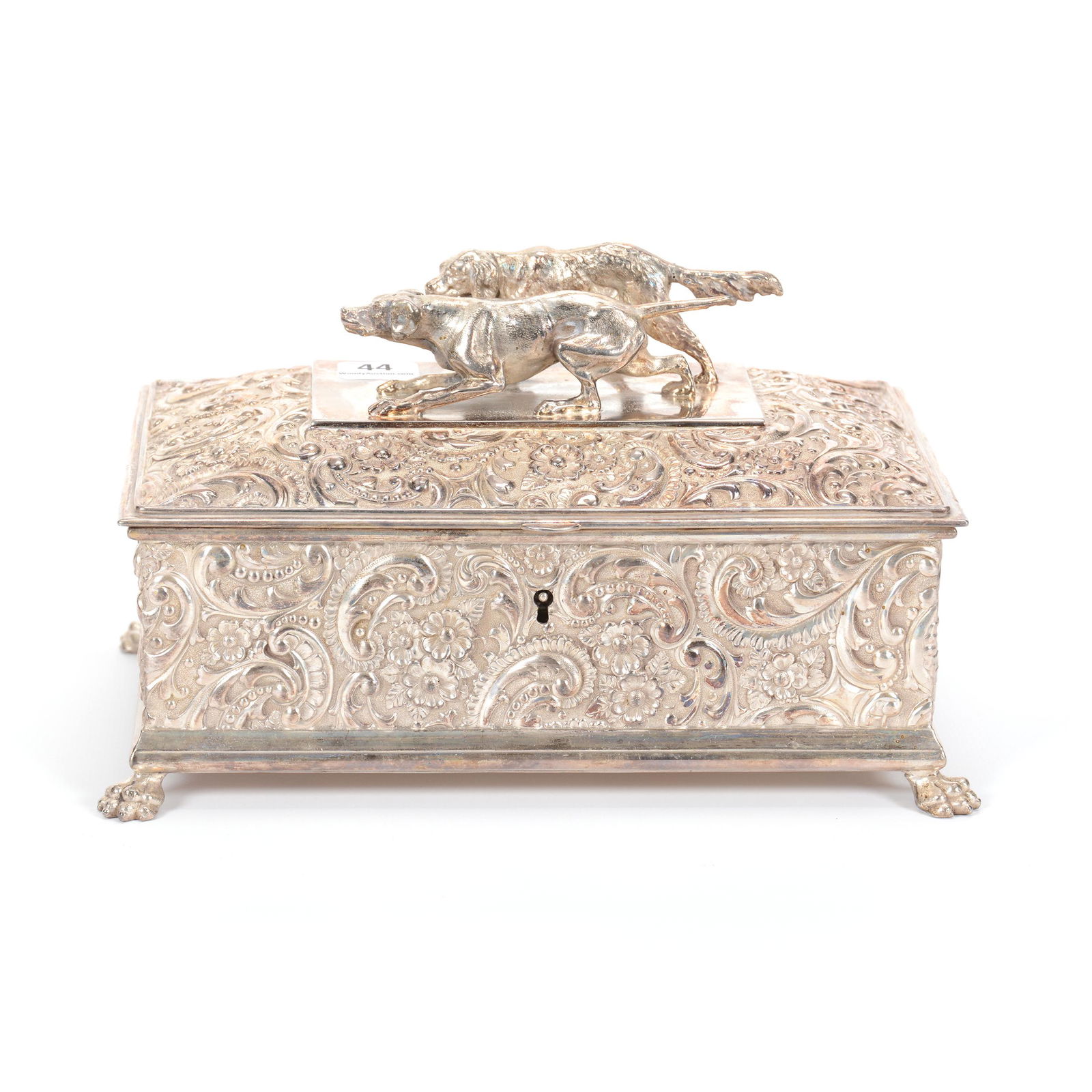 Humidor, Silverplate Marked Wilcox #7700: Humidor, Silverplate Marked Wilcox #7700, 5.5" X 9" X 5.5", Elaborate Floral and Scroll Design, Two Figural Hunting Dogs on Lid, Original Key Included with Box; the Collection of Mrs. R. and the Late
