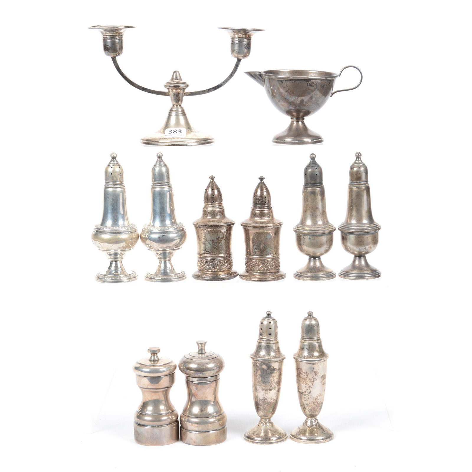 (12) Pieces Sterling Silver, All with Weighted Bases: (12) Pieces Sterling Silver, All with Weighted Bases, (10) Salt and Pepper Shakers, (1) Creamer, (1) Double Arm Candlestick; the Collection of Mrs. R. and the Late Dr. S. Alexander.