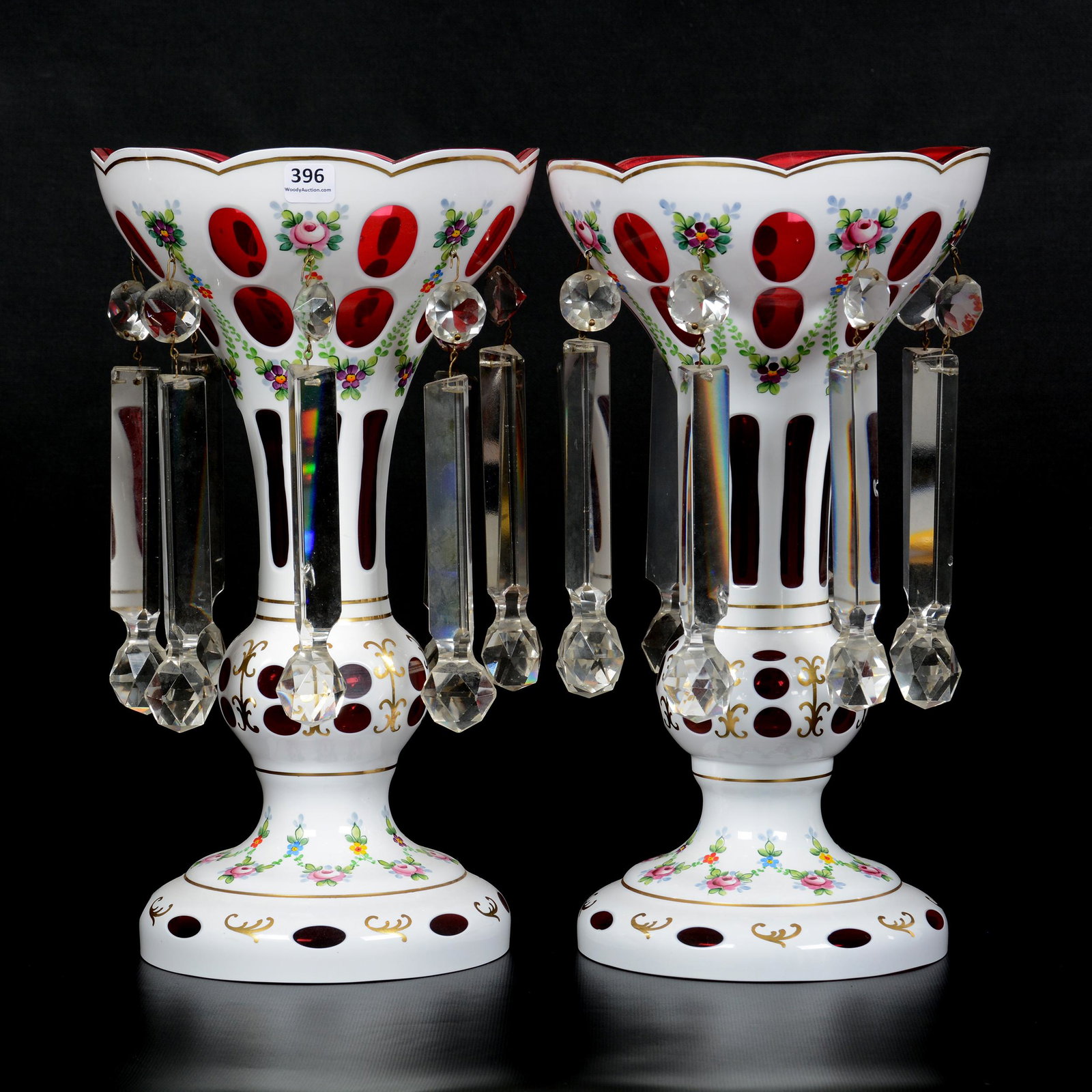 Pair Cranberry Overlay Candle Lustres: Pair Cranberry Overlay Candle Lustres, 15" X 8", Large Prisms, Floral and Gold Stencil Decor, Circa 1960's, Some Chips on Some Prisms; the Collection of Mrs. R. and the Late Dr. S. Alexander.