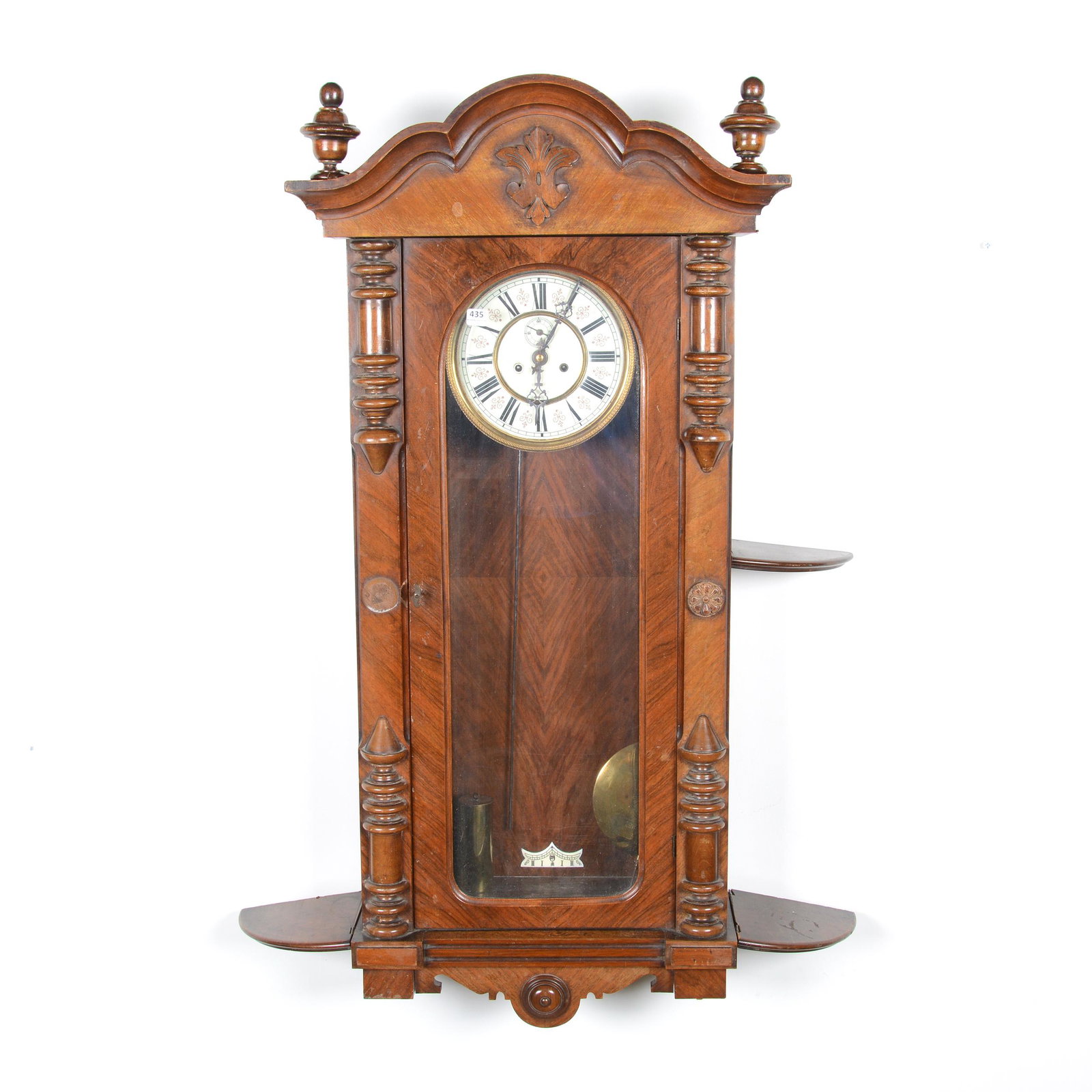 German Regulator Clock, Walnut Case: German Regulator Clock, Walnut Case, 41" X 28", Two Weights, Pendulum, Three Drop Down Shelves on Each Side, One Shelf Missing, Beveled Glass Front, Bottom Crest Needs Re-Attached, Possibly Missing a 