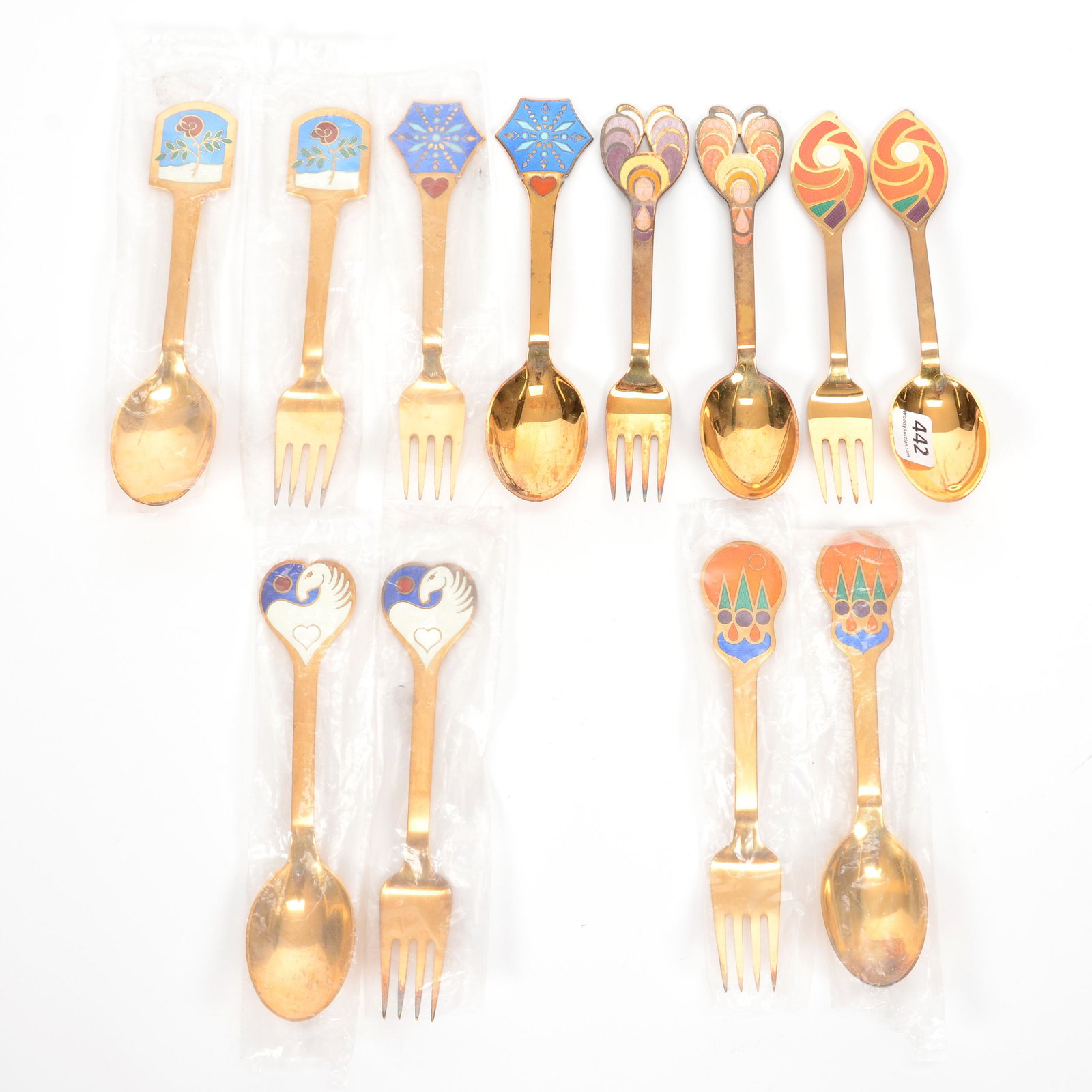 (6) Michelsen Christmas Fork & Spoon Sets: (6) Michelsen Christmas Fork & Spoon Sets, (1) 1971, Golden Universe, Designed by Else Alselt, (1) 1972, Herald, Designed by Bjorn Windlad, (1) 1976, Snow Crystal, Designed by Gudmund Olsen, (1) 1977,