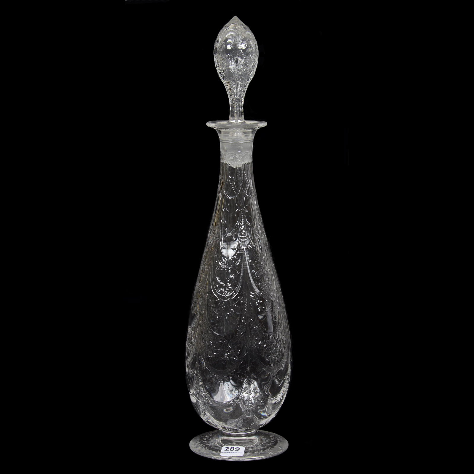 Footed Decanter, ABCG, Teardrop Form: Footed Decanter, ABCG, Teardrop Form, 6.5", Rock Crystal Engraved with Pattern Engraved Stopper and Foot, Elaborate Ribbon Drapes Containing Floral, Fruit and Clear Motifs, Very Similar to Steuben Des