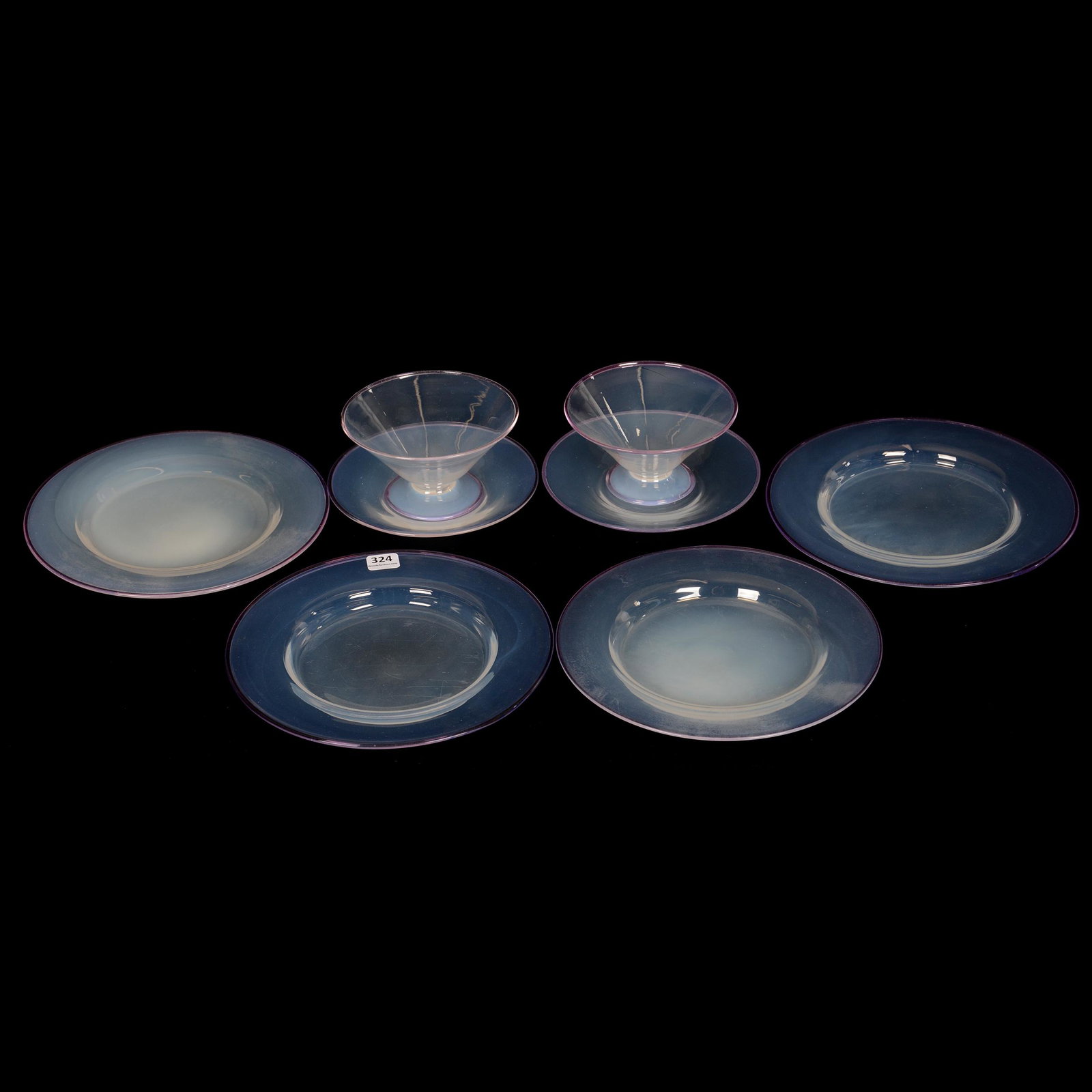 (6) Items by Steuben Art Glass: (6) Items by Steuben Art Glass, Clear Opalescent Body with Amethyst Cintra Rim, (4) 8.5" Plates, (2) 2.75" x 6" Sherbets with Underplates, The Estate of Les Hamilton. UPDATED 10-8-20: Corrected color.
