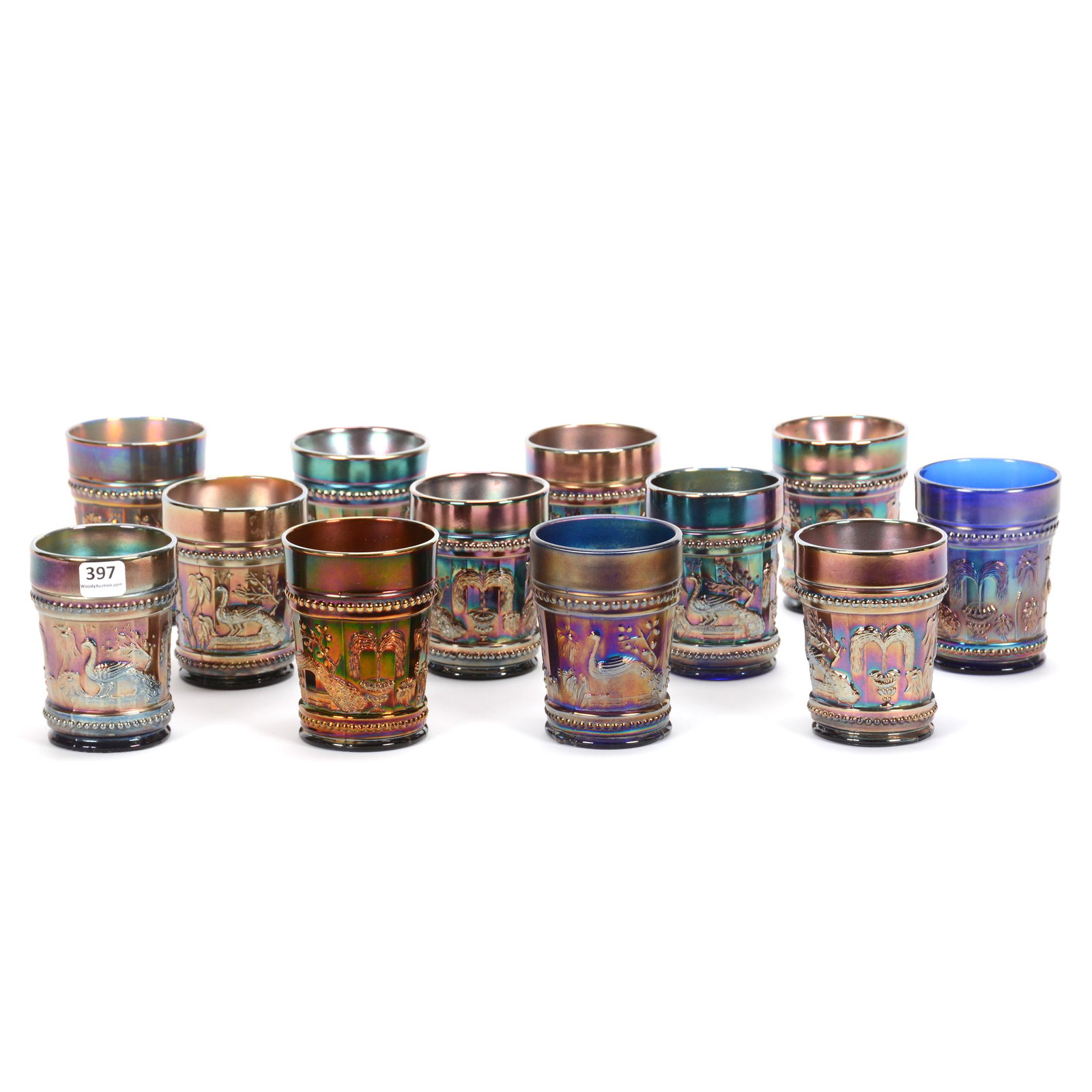 (12) Tumblers, Carnival Glass, Blue Peacock at Fountain: (12) Tumblers, Carnival Glass, Blue Peacock at Fountain, Tumblers All Same Pattern, Some by Northwood, Some by Dugan, Sizes from 3.875" to 4.25", John Lolley Estate, Monroe, LA. The majority of Mr. Lo