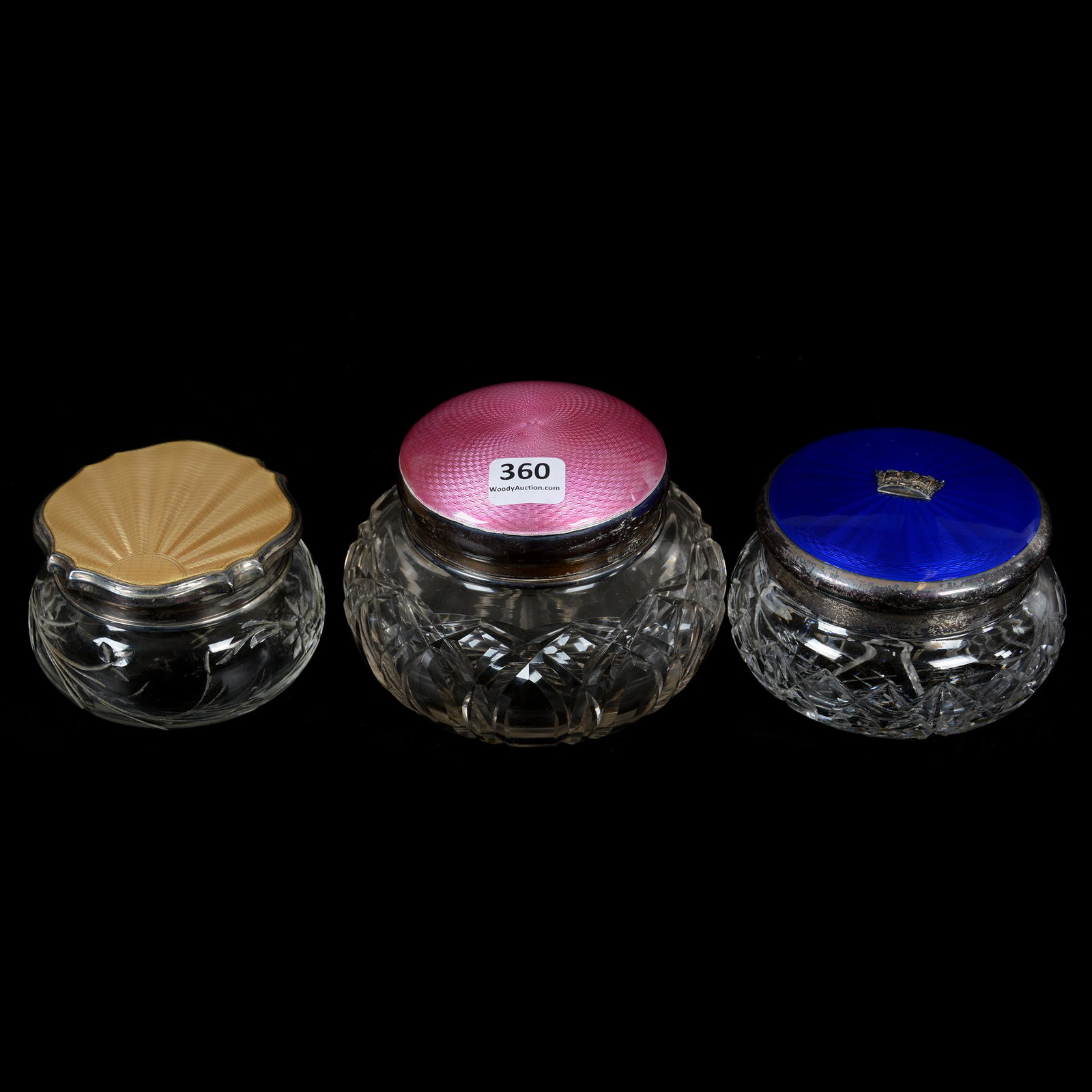 (3) Cut Glass Powder Jars With French Enamel Lids: (3) Cut Glass Powder Jars With French Enamel Lids, (1) 3.5" X 4.75", Arch Cut Design, Ray Cut Base, Pink French Enamel Design Lid, (1) 2.75" X 4", Diamond And Fan Motif, Silver Hallmark Lid With Blue 