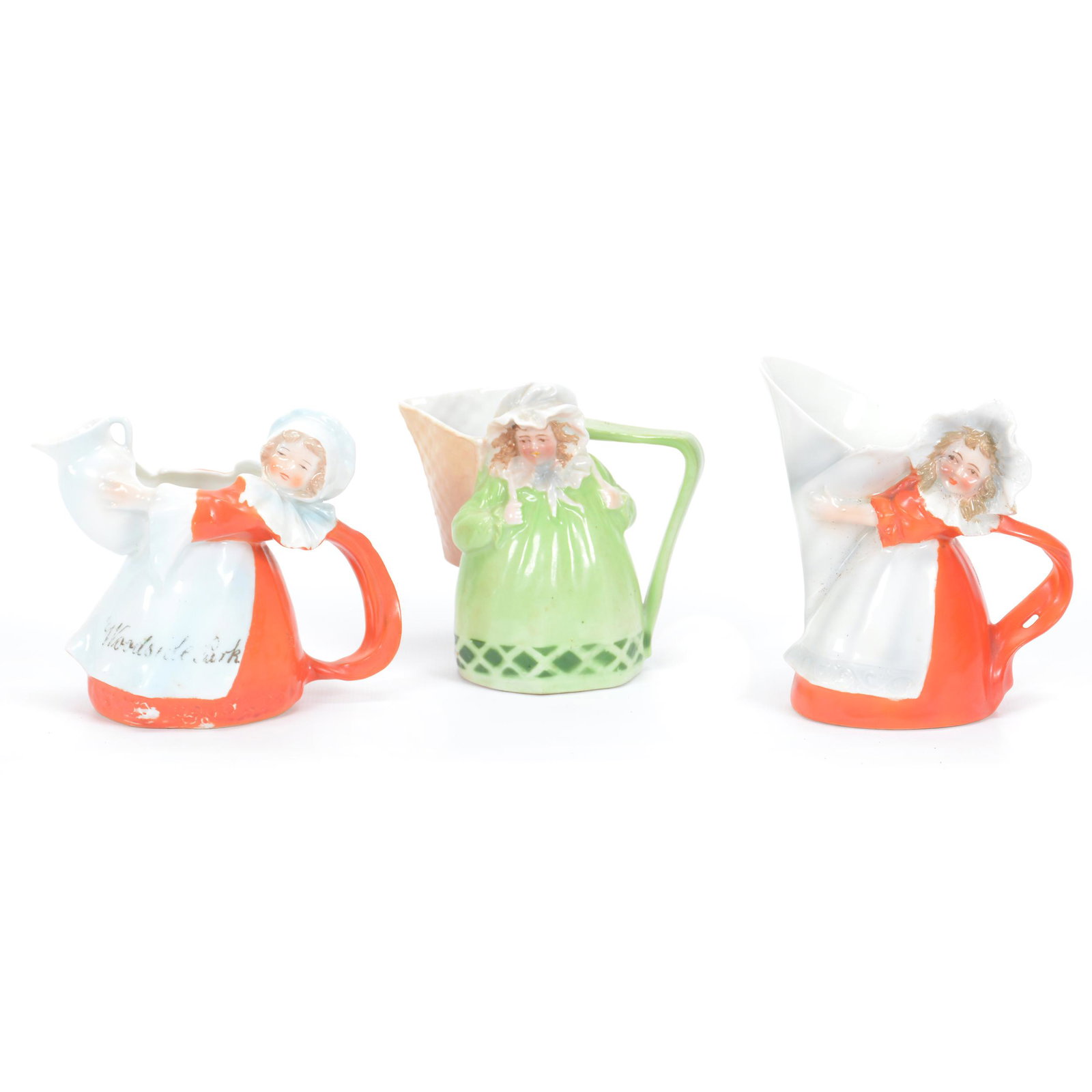 (3) Creamers Marked Royal Bayreuth, Maids: (3) Creamers Marked Royal Bayreuth, Maids, Blue Mark, (1) 4.75" Maid Holding Funnel, Red Dress, (1) 4.25" Maid With Basket, Green Dress, (1) 4.25" Maid Holding Jug, Red Dress, Private Midwest Collecti