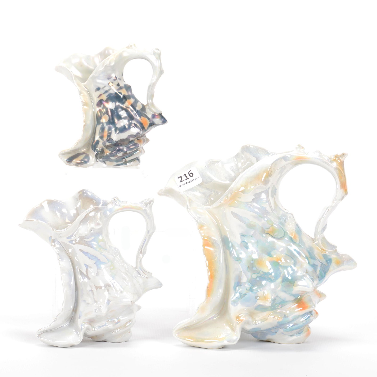 (3) Pitchers Unmarked Royal Bayreuth Spiky Shell: (3) Pitchers Unmarked Royal Bayreuth Spiky Shell, Boot Shape, (1) 7.25" Water Pitcher, White, Blue And Orange Lustre Finish, (1) 5.5" Milk Pitcher, White Lustre, (1) 4.5" Creamer, White, Black And Ora