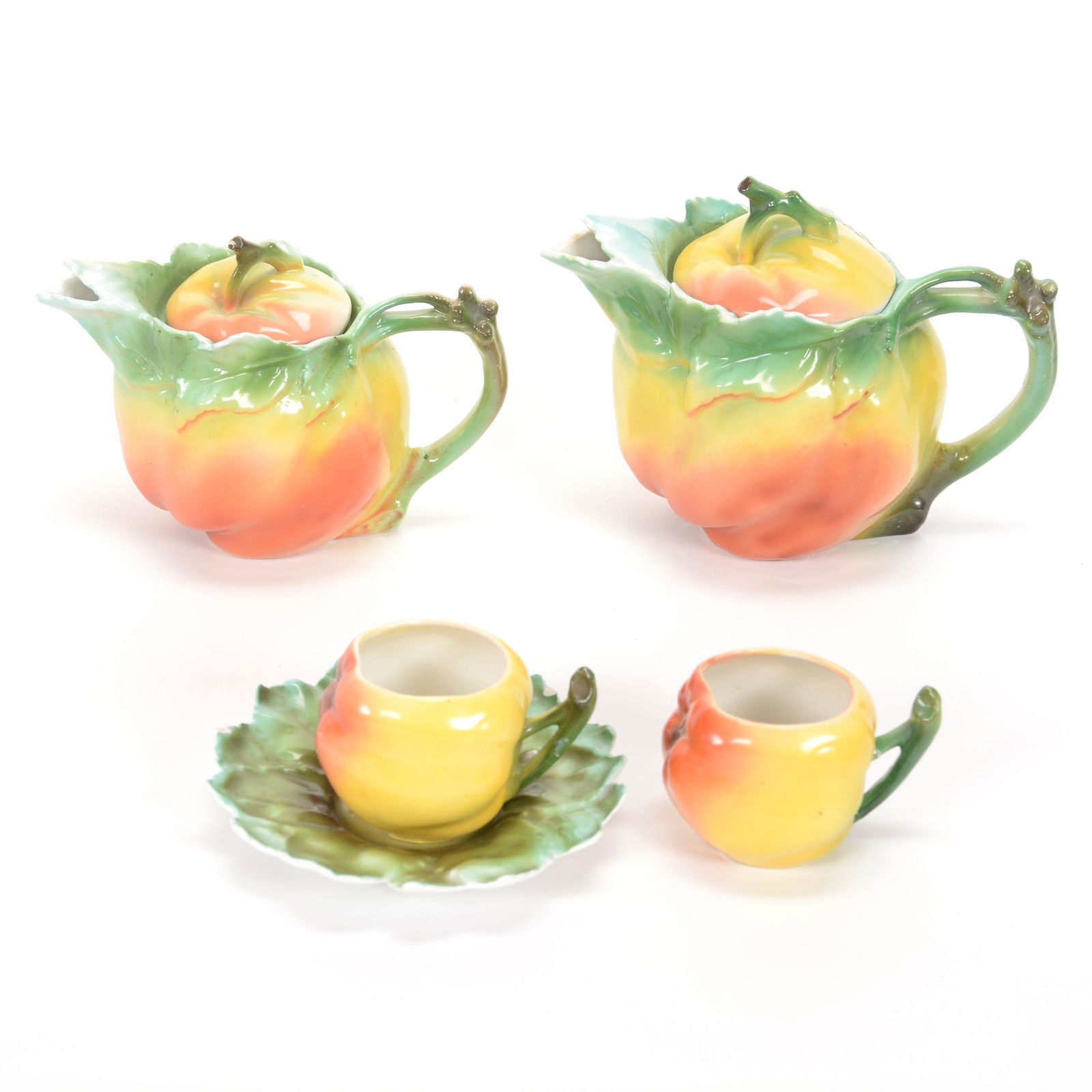 (4) Royal Bayreuth Yellow Apple Items: (4) Royal Bayreuth Yellow Apple Items, (1) 4.5" X 6" Tea Pot, Blue Mark, (1) 4" X 5.25" Tea Pot, Marked, (1) 2" X 4.5" Cup & Saucer, Unmarked, Saucer Has Two Small Rim Chips, (1) Cup, Unmarked, Handle