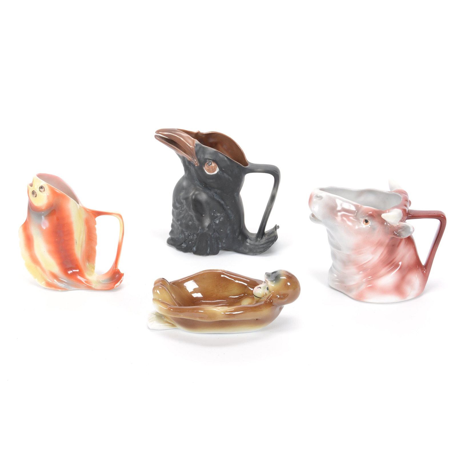 (4) Damaged Or Repaired Royal Bayreuth Items: (4) Damaged Or Repaired Royal Bayreuth Items, (1) 4.75" Crow Creamer, Small Base Nick, (1) 4.25" Flounder Creamer, Tail Chipped, (1) 3.5" Bull, Long Hairline, (1) 5" Pipe Holder, Monkey, Fake Royal Ba