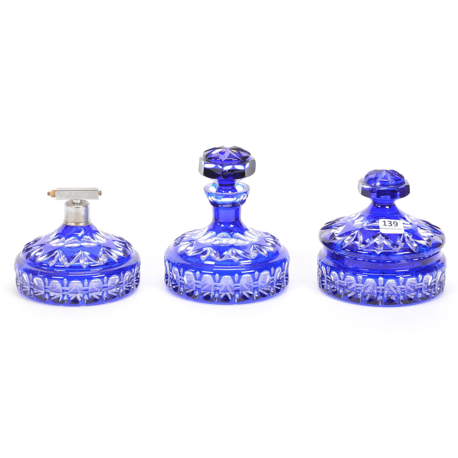 (3) Blue Cut To Clear Vanity Items: (3) Blue Cut To Clear Vanity Items, (1) 5.5" X 4.5" Perfume Bottle (Crack), (1) 4.5" X 4.5" Covered Powder Box (Rim Chips & Bruise), (1) 4" X 4.5" Atomizer, Bulb Missing, Unknown Age, Missouri private