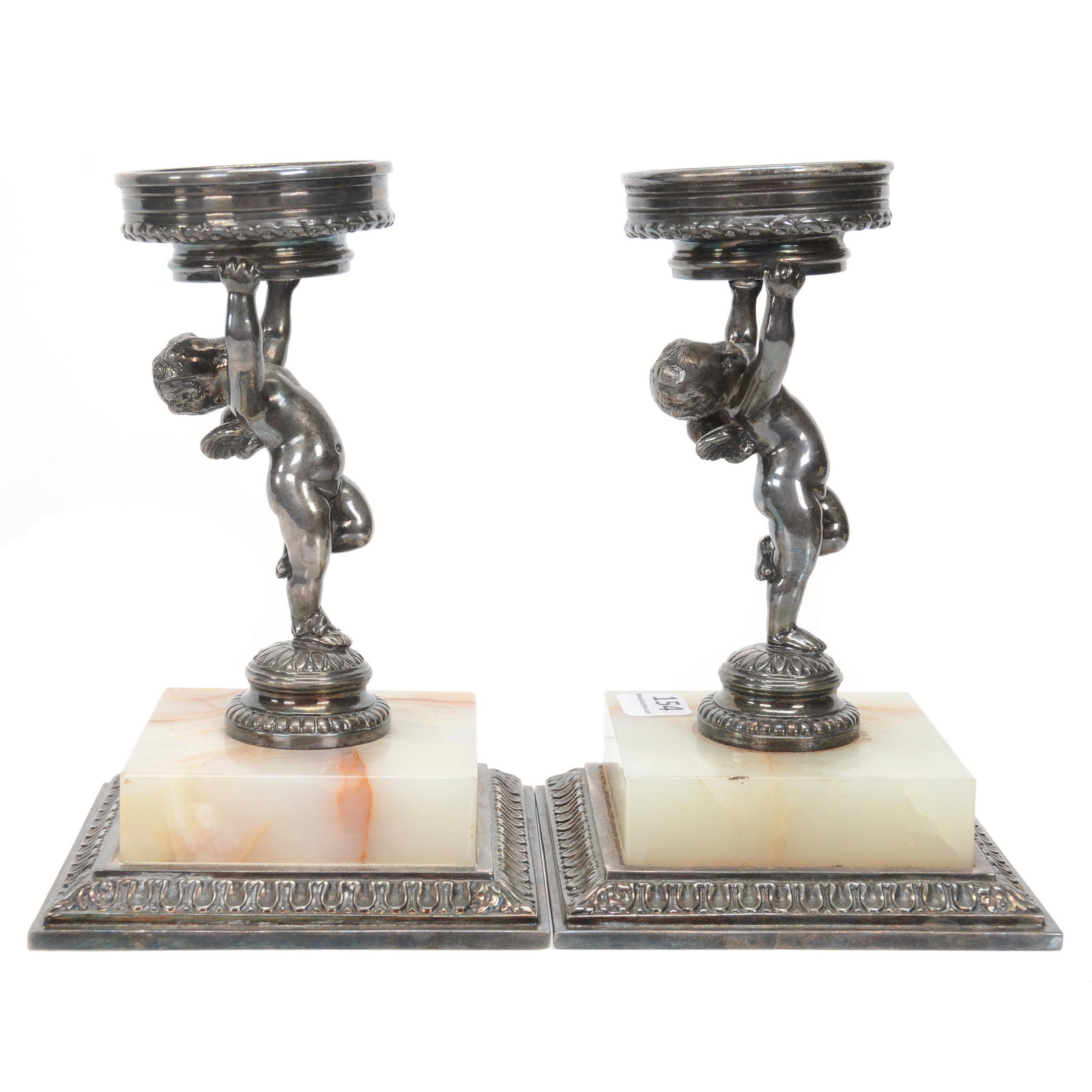 Pair Figural Silverplate/Marble Stands: Pair Figural Silverplate/Marble Stands, 7" X 4.5", Marked Pairpoint #C1433, Featuring Cherub Holding Stand Above Head, No Inserts, 2.25" Opening To Fit Insert, Nebraska Collection Of Ron & Pam Blessin