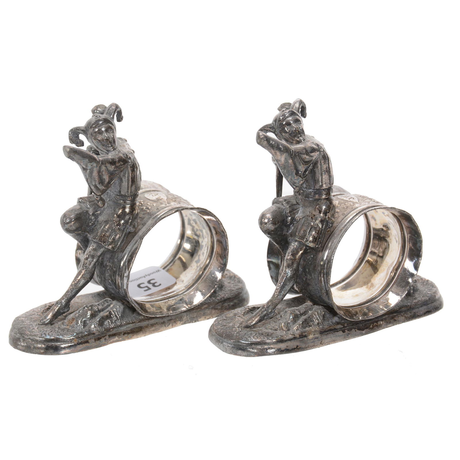 Pair Napkin Rings, Meriden #0258 Silverplate: Pair Napkin Rings, Meriden #0258 Silverplate, 3.5" X 4", Each Features A Jester, Jester On Each Is Missing Left Hand, Dan & Mary Arnold Collection