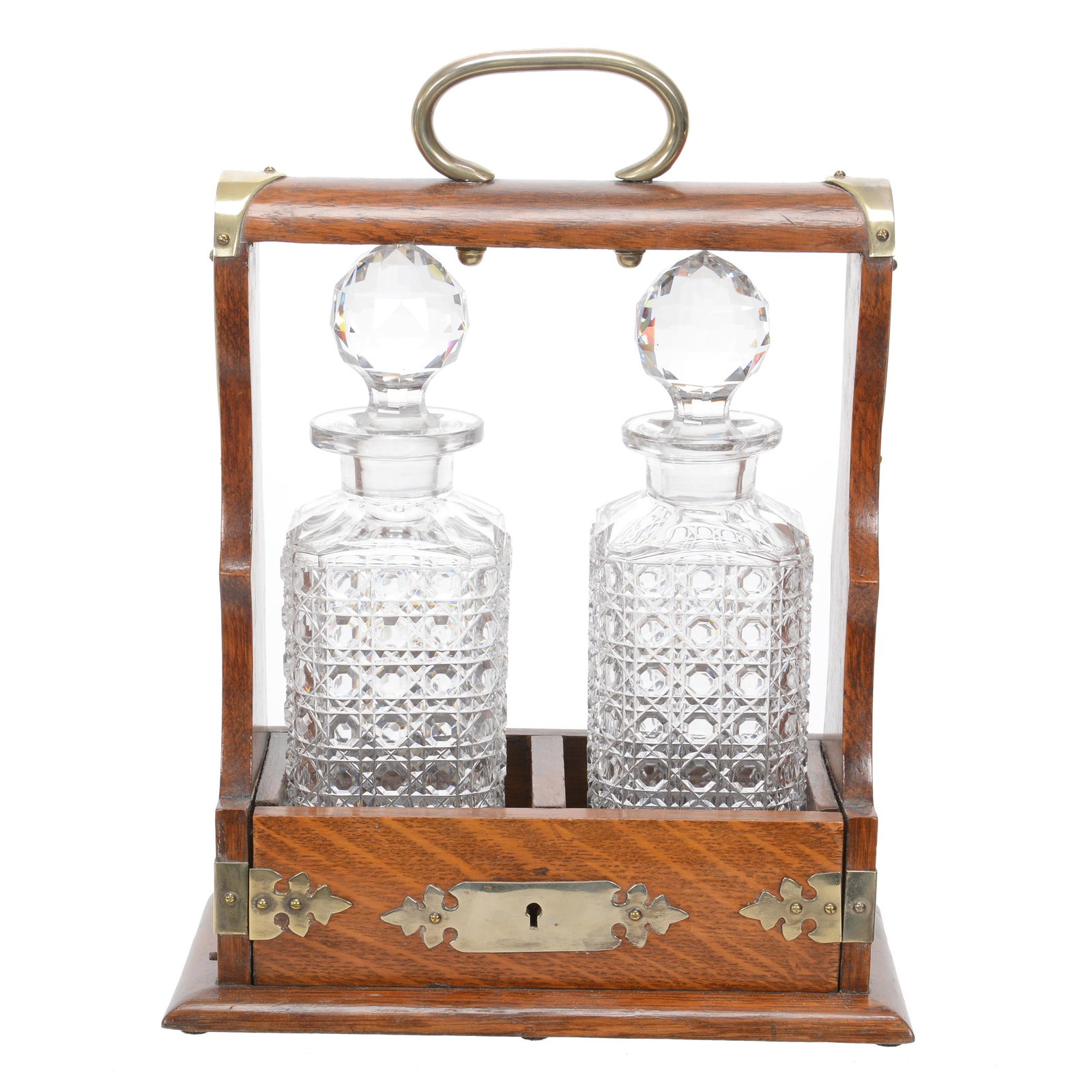 English Tantalus Set, Two Bottles: English Tantalus Set, Two Bottles, 13" X 10" X 5.5", Square Cane Cut Glass Bottles Set In Oak Lockable Cabinet, Bottles May Not Be Original To This Case, Dan & Mary Arnold Collection