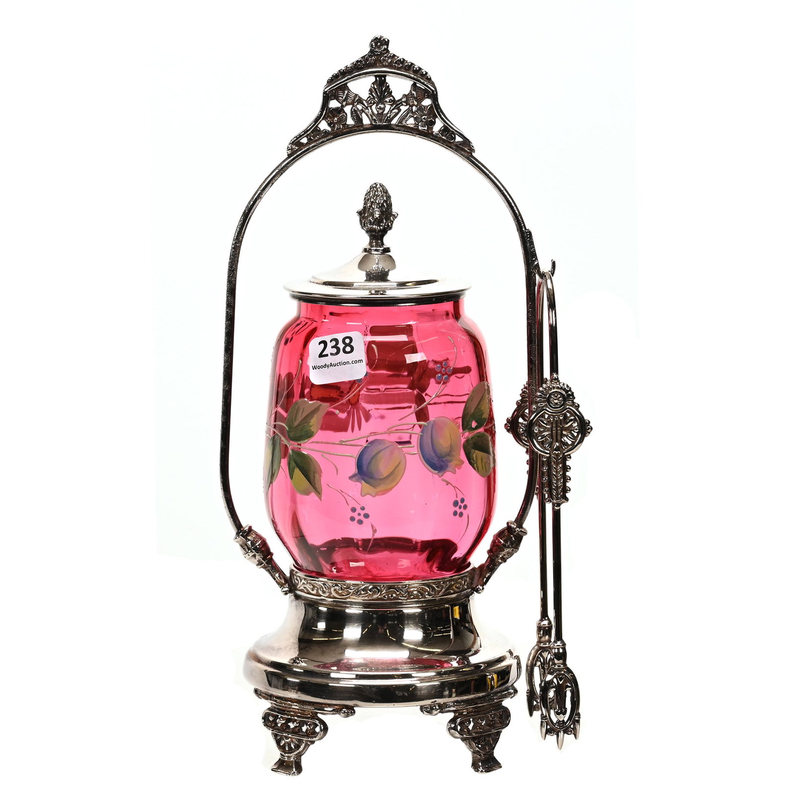 Victorian Pickle Castor, Cranberry Art Glass Insert: Victorian Pickle Castor, Cranberry Art Glass Insert, 10.75" x 5", Enamel Floral Decor, Set On Lexington #09 Silverplate Frame, The David & Marlene Howard Collection.