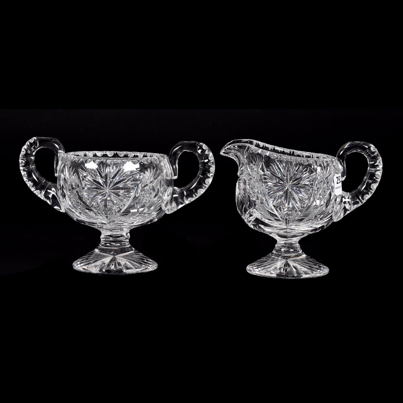 Pedestal Creamer & Sugar, ABCG: Pedestal Creamer & Sugar, American Brilliant Cut Glass, 4.75" x 7", Pattern Resembles Palm By Taylor Brothers, Double Notched Handles, Ray Cut Foot, From The Collection Of Barbara And The Late Dr. Wil