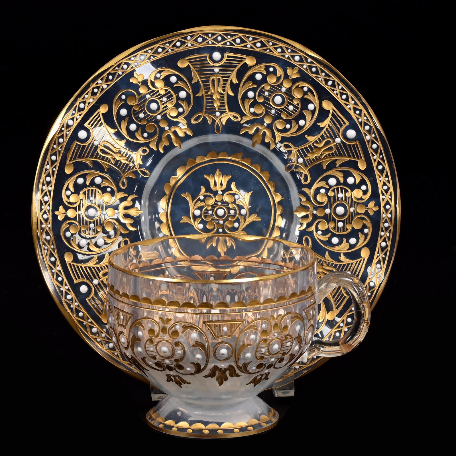 Cup & Saucer, White Opal Bohemian Art Glass: Cup & Saucer, White Opal Bohemian Art Glass, 2.25" x 4.75", Engraved Scroll Design With Gold And White Enamel Beaded Highlights, Don Henson Estate, Michigan. Part 3. This auction is the final dispersa