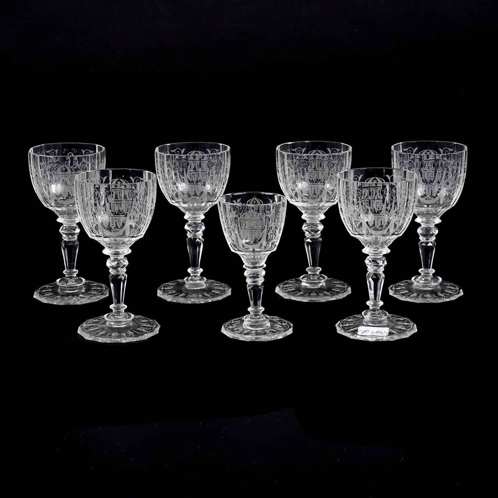 (7) Wine Stems Marked Lobmeyr Bohemian Crystal: (7) Wine Stems Marked Lobmeyr Bohemian Crystal, Panel Cut, Engraved Castle, Urn And Scroll Design, (6) 4.75" X 2.25", (1) 4" X 2", Same Pattern As Lot #99 & #100, Don Henson Estate, Michigan. Part 3. 