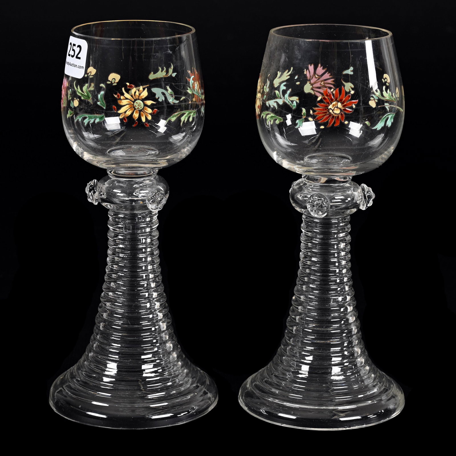 Pair Wine Stems, Clear Bohemian Art Glass: Pair Wine Stems, Clear Bohemian Art Glass, 7.25" x 3.25", Colorful Enamel Floral Decor, Ring Skirted Base With Applied Prunts, Don Henson Estate, Michigan. Part 3. This auction is the final dispersal 