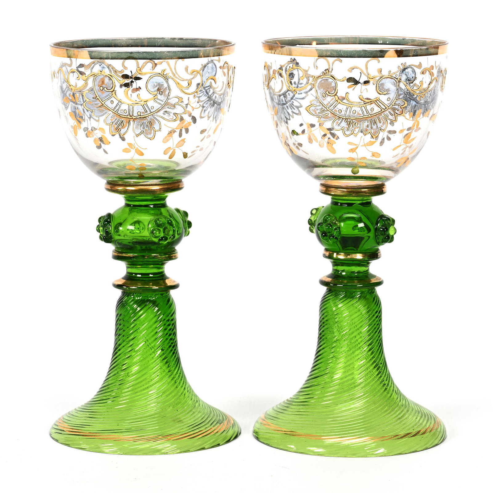 Pair Wine Stems, Clear Bohemian Art Glass: Pair Wine Stems, Clear Bohemian Art Glass, 6" x 3", Green Stem And Foot, Swirl Mold Skirted Base, Applied Prunts, Scroll Enamel Decor, Don Henson Estate, Michigan. Part 3. This auction is the final di
