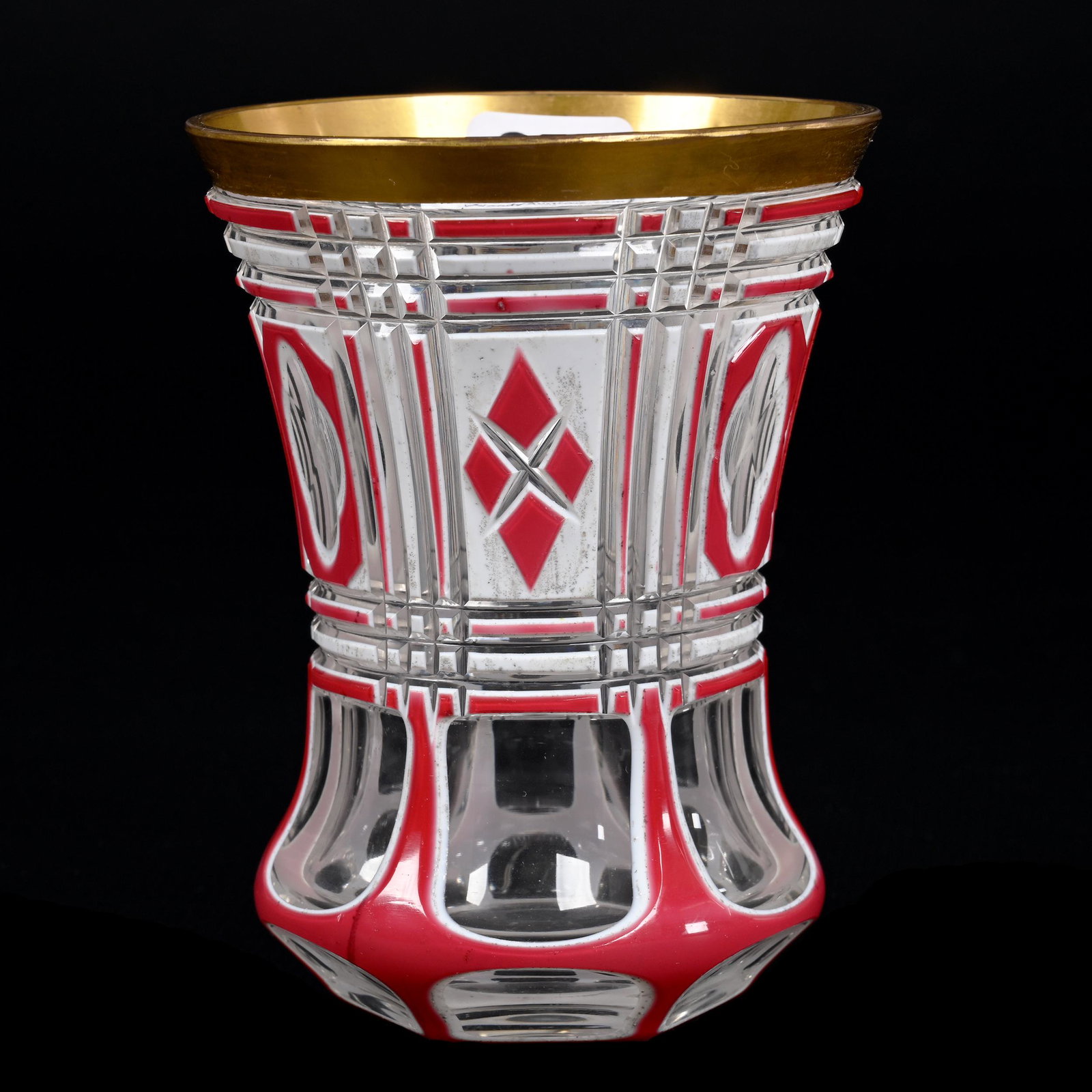 Beaker, Clear Bohemian Art Glass: Beaker, Clear Bohemian Art Glass, 4.5" x 3.25", White And Pink Cutback Overlay, Six Panel Cuts With Geometric Designs, Factory Flaw On Base (See Photos), Don Henson Estate, Michigan. Part 3. This auct