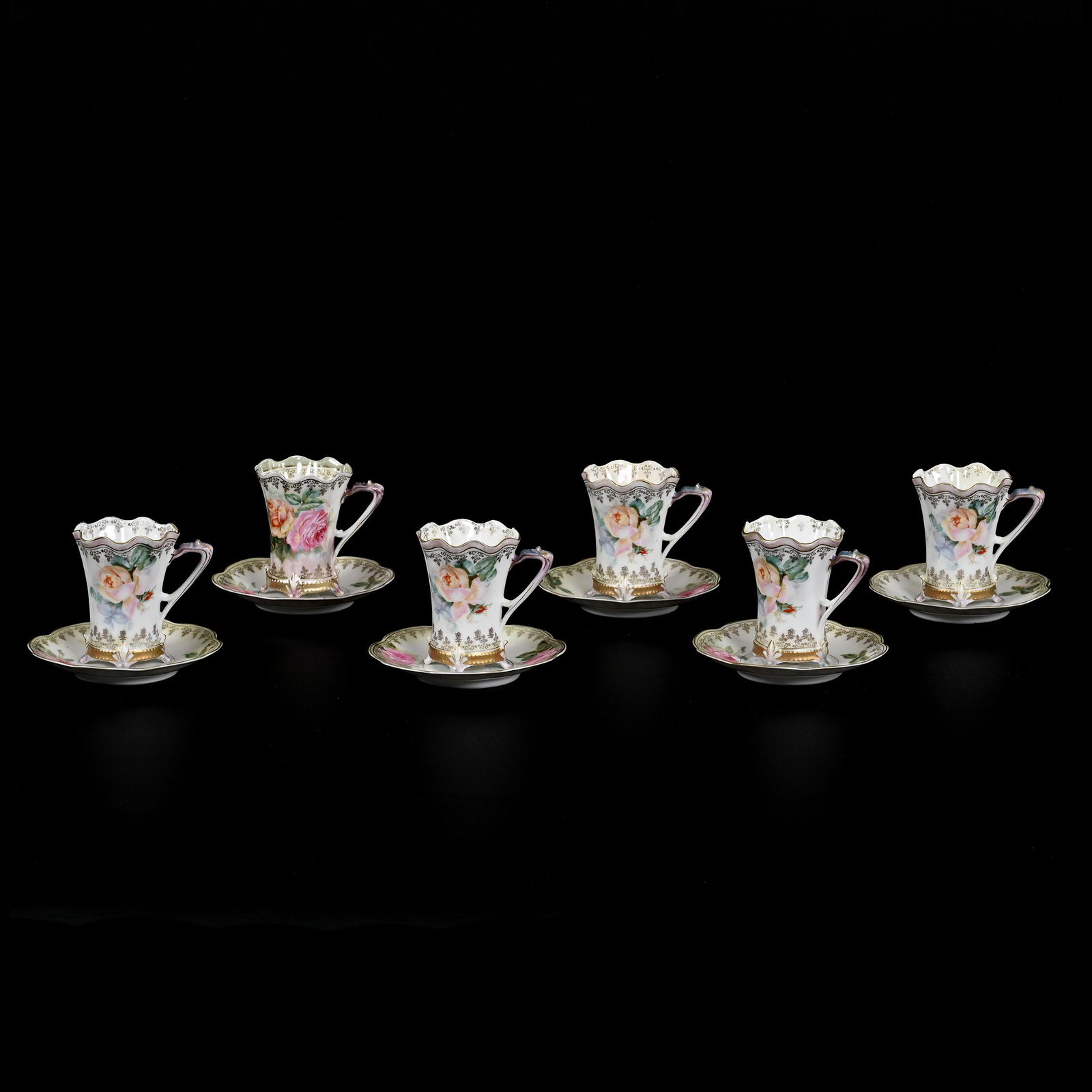 (6) Matching Cups & Saucers Marked R.S. Prussia: (6) Matching Cups & Saucers Marked R.S. Prussia, 3.5" x 4.75", Footed, White And Green Satin, Rose Decor, Gold Stencil Highlights, The David & Marlene Howard Collection.