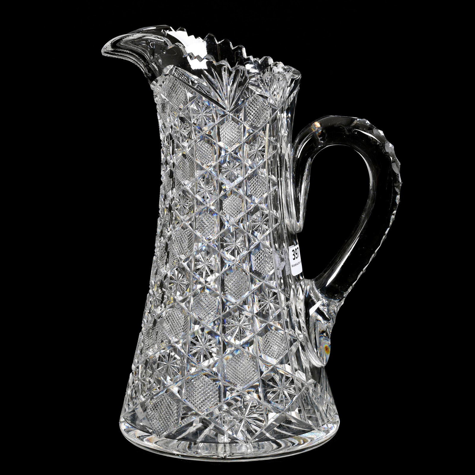 Water Pitcher, American Brilliant Cut Glass: Water Pitcher, American Brilliant Cut Glass, 10" x 7.5", Alternating Buttons Of Star And Strawberry Diamond, Triple Notched Handle, Ray Cut Base, Carl Putzka Collection, Texas.