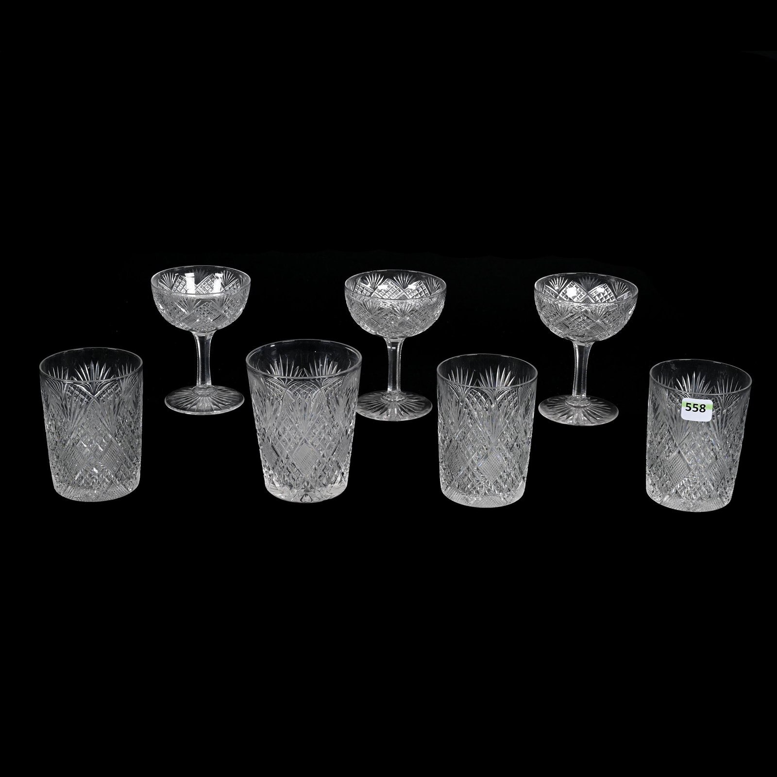 (7) Tumblers & Champagnes, American Brilliant Cut Glass: (7) Tumblers & Champagnes, American Brilliant Cut Glass, All Crosscut Diamond, Strawberry Diamond And Fan Motif With Ray Cut Base, All Have Original Rims, (3) 4.5” x 3.5", (1) 4.5” x 3.5", (1) 4.2