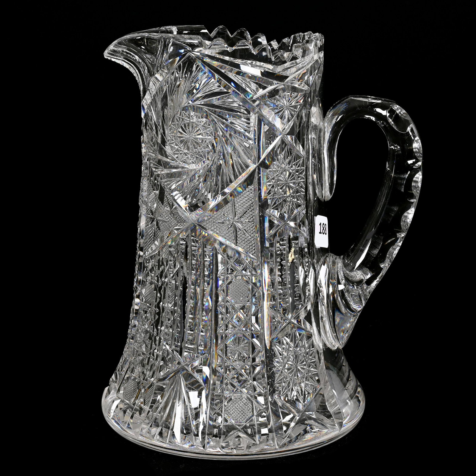 Pitcher, American Brilliant Cut Glass: Pitcher, American Brilliant Cut Glass, 9" x 7.25", Pinwheel, Hobstar, Prism, Star And Fan Motif, Ray Cut Base, Some Interior Rim Tooth Chips, Estate Of Dr. Barry and Dee Free.