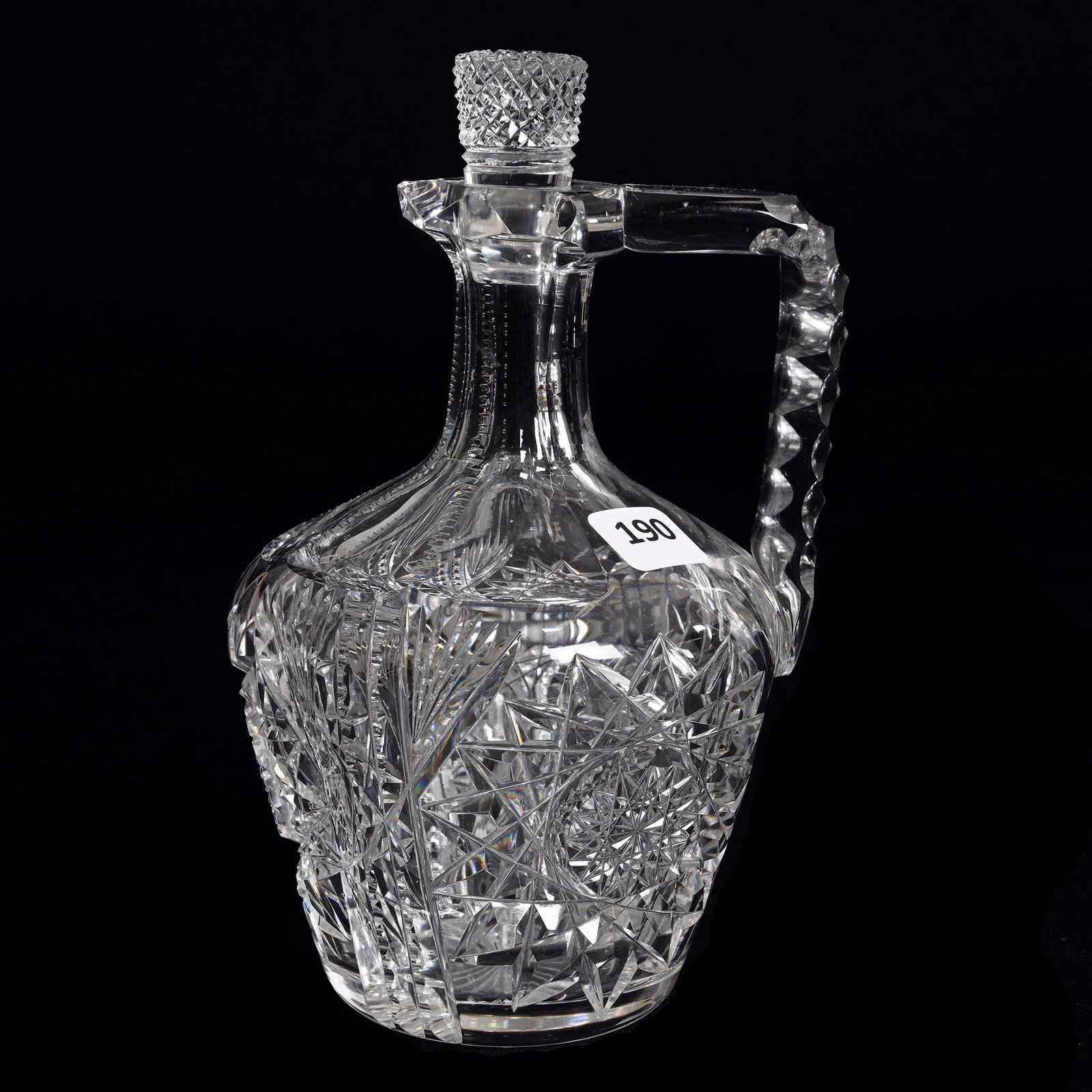 Whiskey Jug, American Brilliant Cut Glass: Whiskey Jug, American Brilliant Cut Glass, 7.75" x 4.75", Hobstar, Prism And Fan Motif, Pattern Cut Stopper, Triple Notched Handle, Ray Cut Base, Estate Of Dr. Barry and Dee Free.
