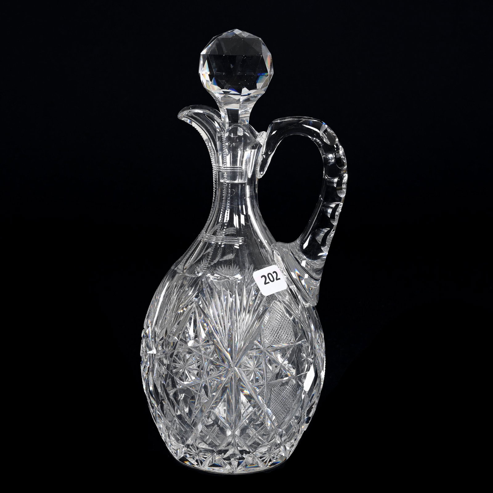 Decanter, American Brilliant Cut Glass: Decanter, American Brilliant Cut Glass, 11.5" x 5", Modified Hobstar, Strawberry Diamond, Crosshatch, Star And Fan Motif, Double Notched Handle, Ray Cut Base, Estate Of Dr. Barry and Dee Free.