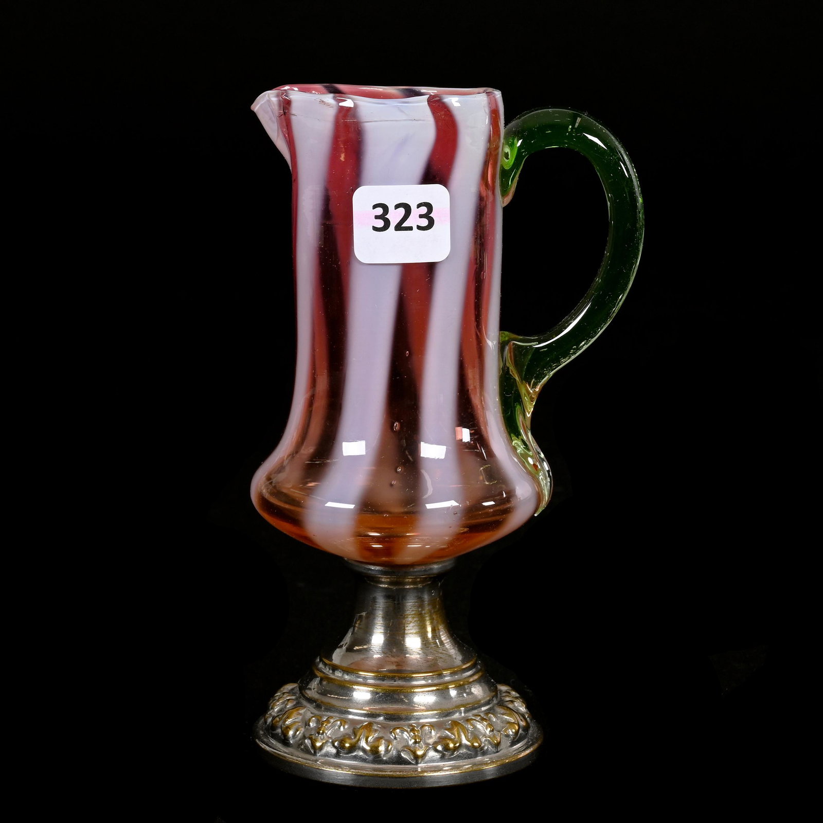 Pedestal Creamer, Cranberry Opalescent Stripe: Pedestal Creamer, Cranberry Opalescent Stripe, 6.25" x 3.5", Applied Vaseline Handle, Silverplate Foot, Tail Of Handle Has Small Nick, Estate Of Dr. Barry and Dee Free.