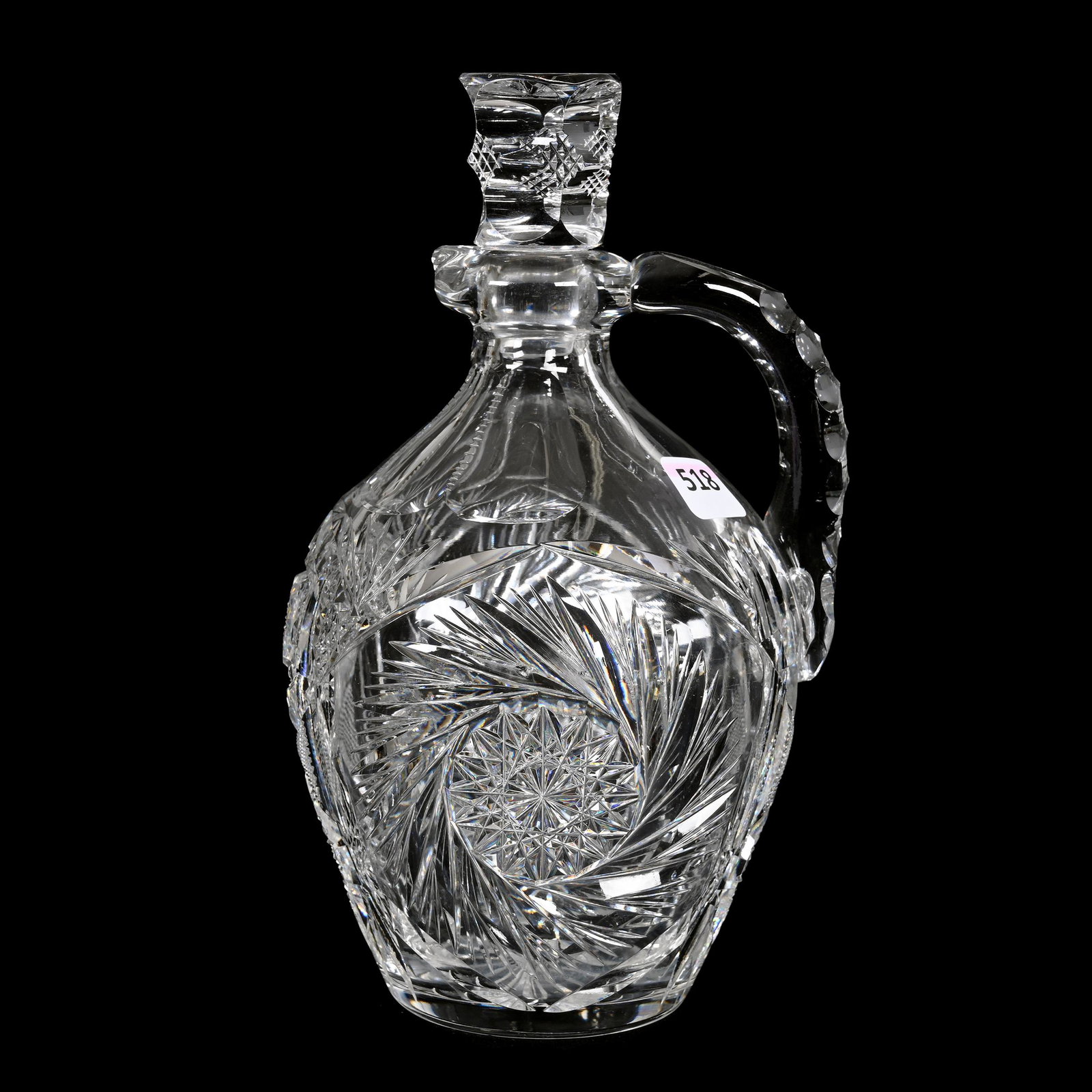 Whiskey Jug, American Brilliant Cut Glass: Whiskey Jug, American Brilliant Cut Glass, 8.5" x 5", Pinwheel, Hobstar, Strawberry Diamond And Fan Motif, Stopper Is Not A Secure Fit (Wrong Stopper), Estate Of Dr. Barry and Dee Free.