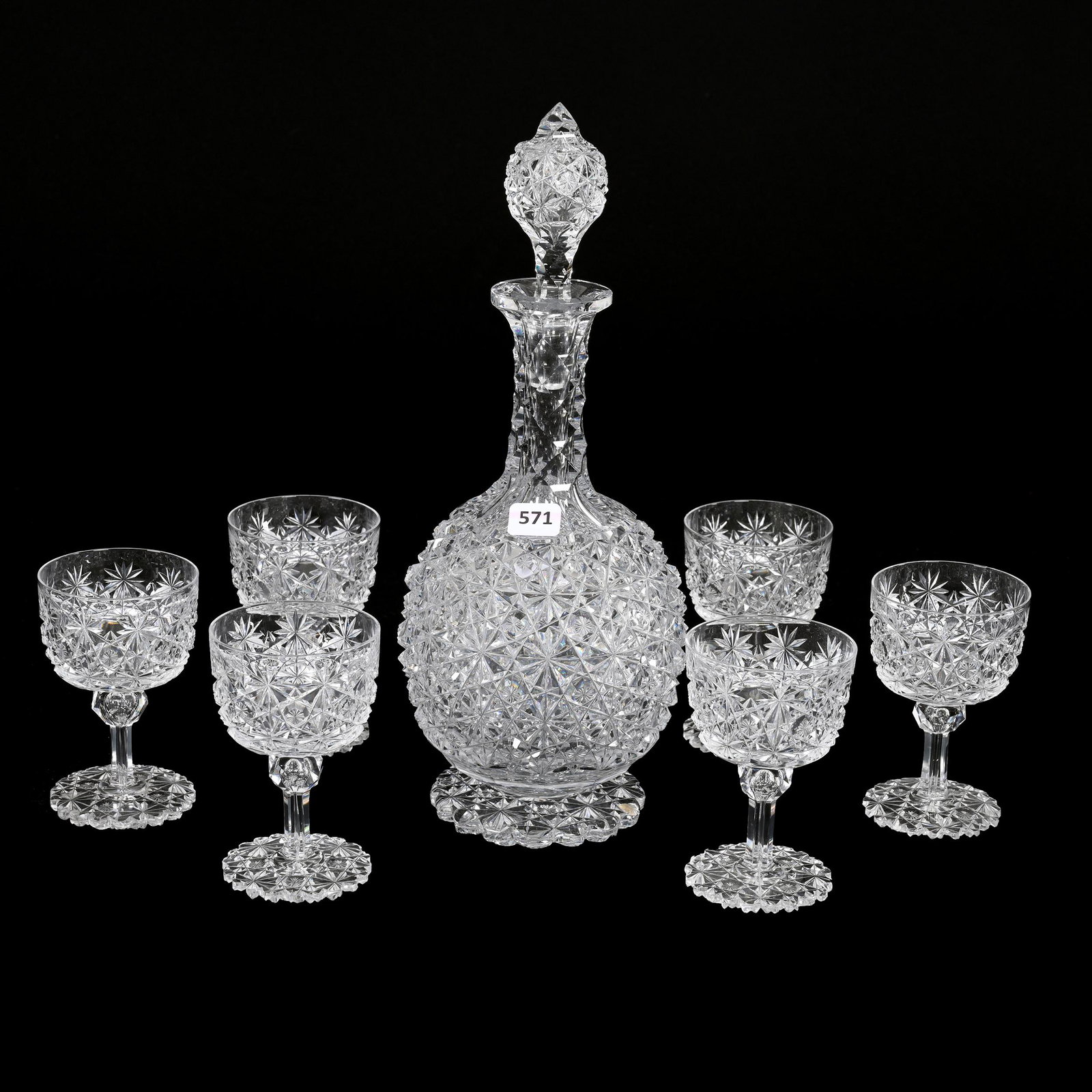 Decanter Set, American Brilliant Cut Glass, Russian Pattern: Decanter Set, American Brilliant Cut Glass, Russian Pattern, Star Cut Buttons, (1) 12.5" x 4.75" Footed Decanter, Pattern Cut Stopper, Scalloped Pattern Cut Foot, Sells With (6) 4.25" x 2.75" Matching
