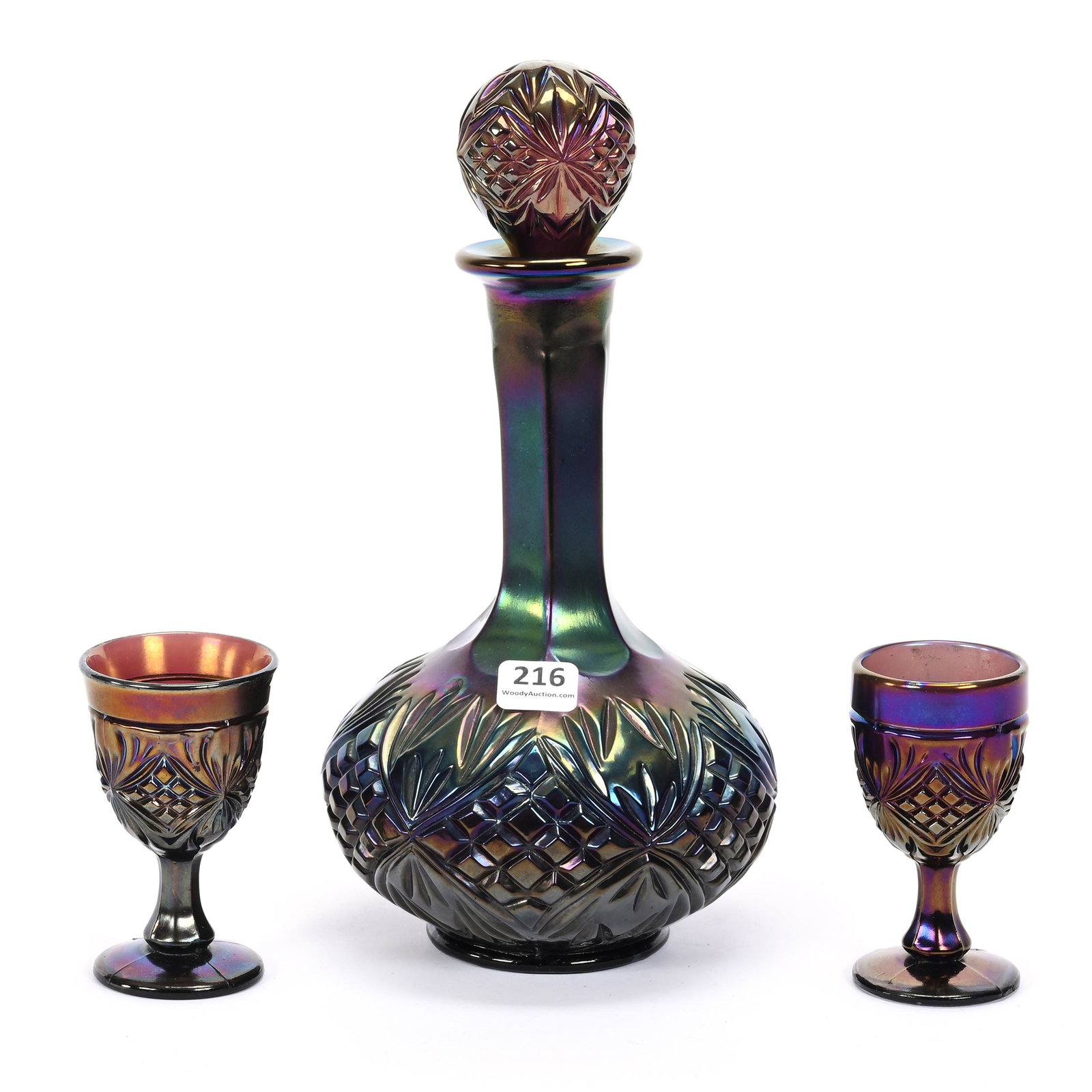 Decanter Set, Carnival Glass, Diamond And Sunburst, Purple: Decanter Set, Carnival Glass, Diamond And Sunburst, Purple, By Imperial, (1) 10" X 5" Decanter, Chips On Stopper Plug, (2) Matching 3.5" Cordials, One Has Base Chip, Dick & Diane Elder Collection.